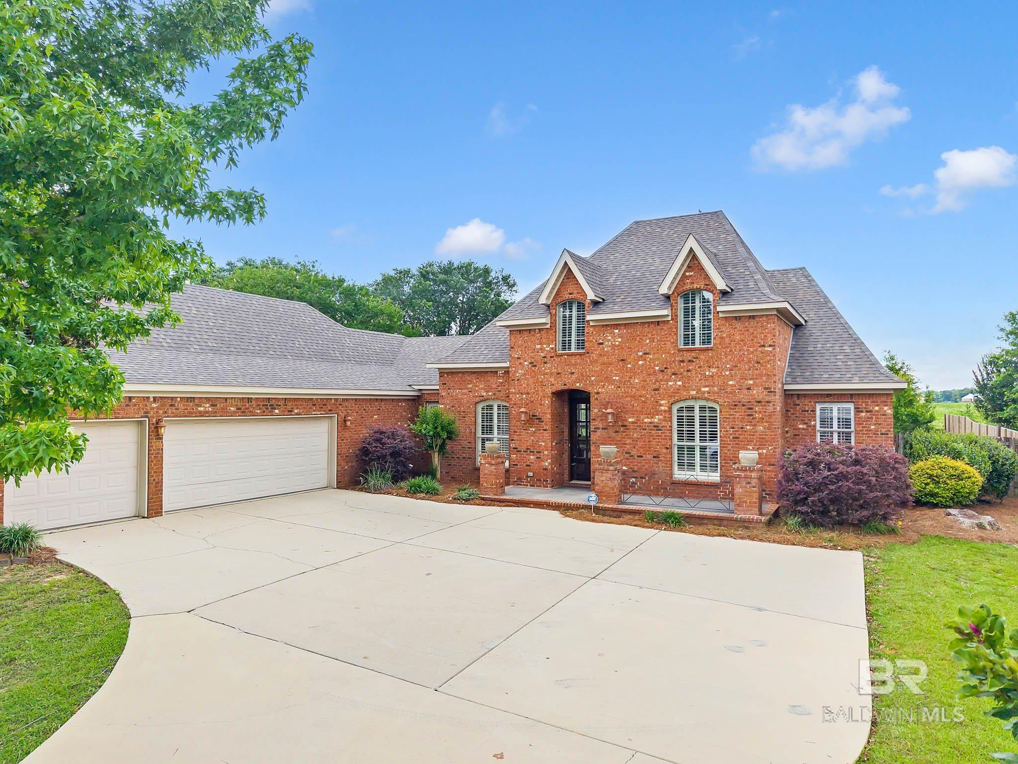 Welcome to this stunning custom brick French Country home nestled on nearly half an acre featuring 4 spacious bedrooms, 3 full bathrooms, a dedicated office, and a separate formal dining room, this home offers both comfort and flexibility. Step inside to find soaring 11-foot ceilings, elegant crown molding, and rich engineered scraped hardwood flooring throughout the main living areas. The front of the home is adorned with charming plantation shutters, while the living room boasts a cozy gas fireplace, custom built-in shelving, and cabinets. The gourmet kitchen is a chef’s dream with granite countertops, stainless steel appliances, a gas range, and a refrigerator that conveys with the home. Bedroom 2 is a private ensuite.  The freshly painted primary suite is tucked away at the rear of the home for ultimate privacy, complete with new roller shades, dual walk-in closets with custom wood shelving, two separate vanities, a large jetted soaking tub, and a separate shower. Enjoy peace of mind with a brand new inside/outside AC unit installed in June 2025 plus a NEW FORTIFIED Roof May 2024. Outside, the fenced backyard with a peach tree backs up to an open field, offering both serenity and space. The 3-car garage provides ample storage, and the home is eligible for a 5.249% assumable VA loan. Residents of Avalon enjoy access to a community pier and a scenic lake stocked with fish. Don’t miss your chance to own this exceptional property—schedule your showing today! Buyer to verify all information during due diligence.