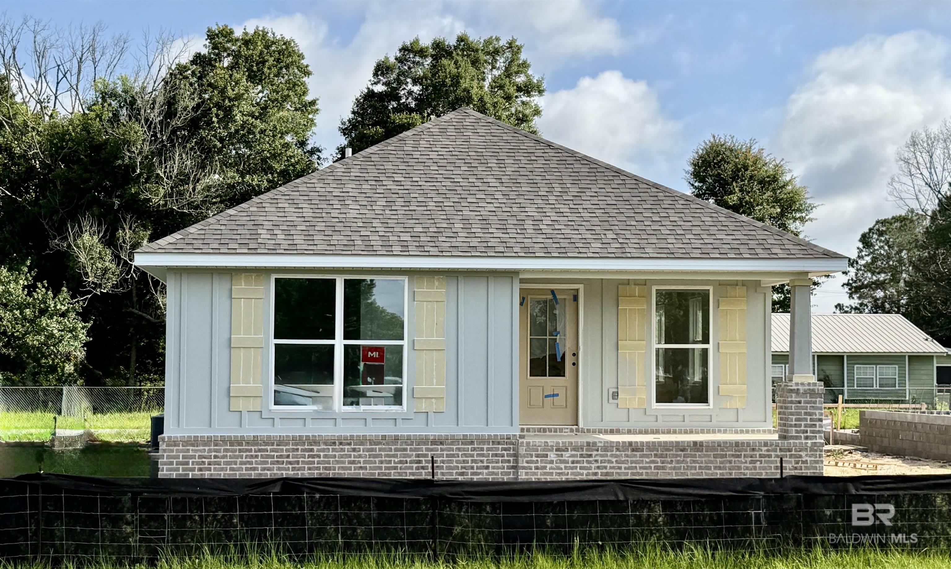 New Home in Loxley featuring Gold Fortified construction, concrete board siding with brick skirt exterior, with large rear covered porch, rear entry garage, and fully sodded lawn. Step inside to the open living area highlighting a vaulted ceiling, recessed lights, and luxury vinyl plank flooring throughout. The kitchen offers 3cm granite countertops, GE appliances, center island, and plenty of cabinet and counter top space. The primary bedroom offers a huge walk-in closet and full bath which includes  an oversized soaking tub, separate shower with glass shower door, and double vanity. Approx. date of completion July 2025. Buyer to verify all information during due diligence.