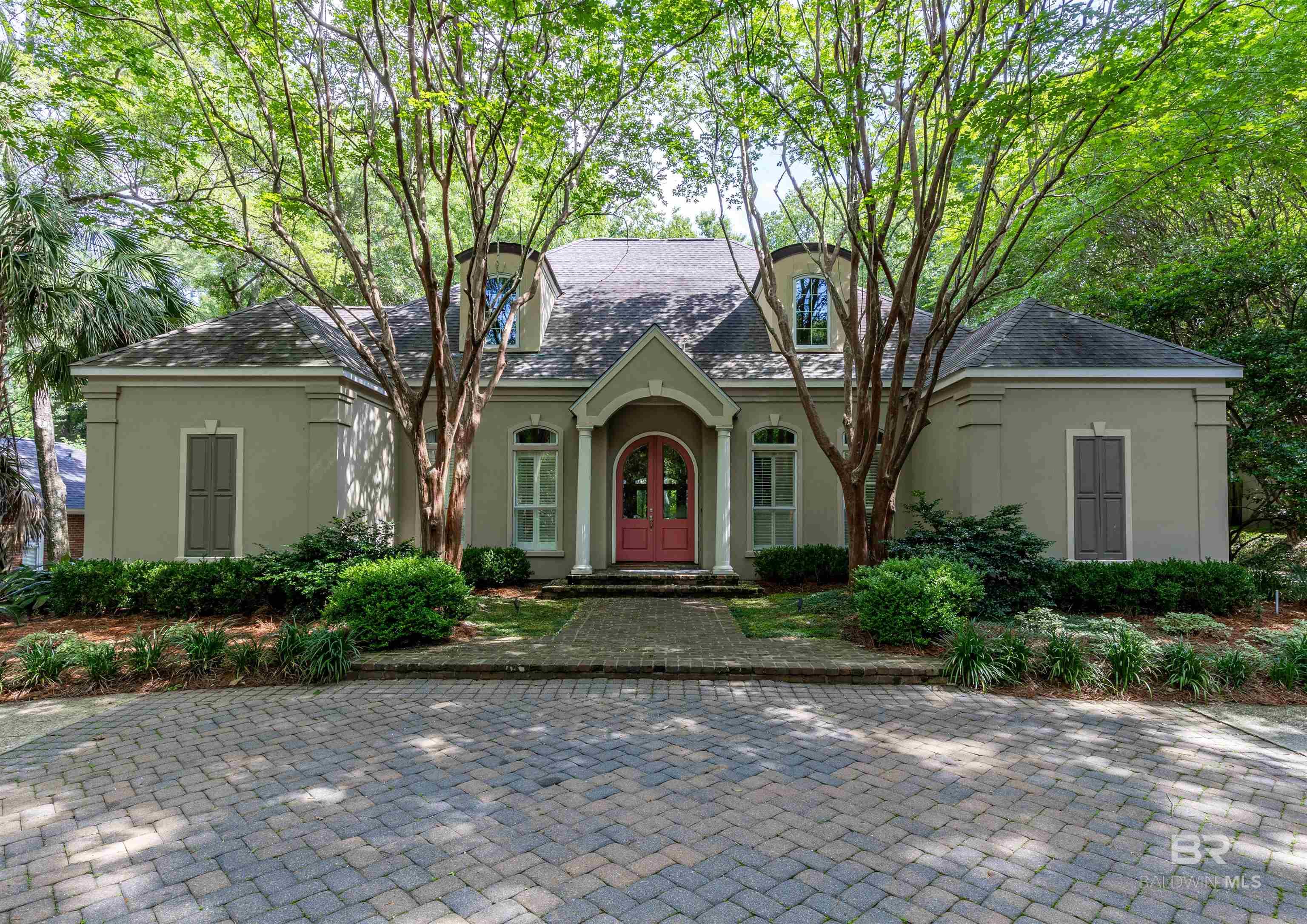 Located in the heart of sought-after Old Town Daphne, this stunning six-bedroom home effortlessly blends classic charm with modern convenience. Beautiful hardwood floors flow throughout a well-designed floor plan, offering four bedrooms on the main level and two additional bedrooms upstairs along with a spacious game room. The gourmet kitchen is an entertainer’s dream, featuring a gas stove, ice maker, and wet bar. The living room offers a warm, inviting feel with a wood-burning fireplace and gas starter. Additional highlights include a whole-home generator, updated HVAC, gas tankless water heater, bronze-certified roof, new gutters, and a beautifully landscaped yard. The slate patio provides the perfect space for outdoor entertaining or peaceful relaxation. A rare opportunity in one of Daphne’s neighborhoods—schedule your private showing today! Buyer to verify all information during due diligence.