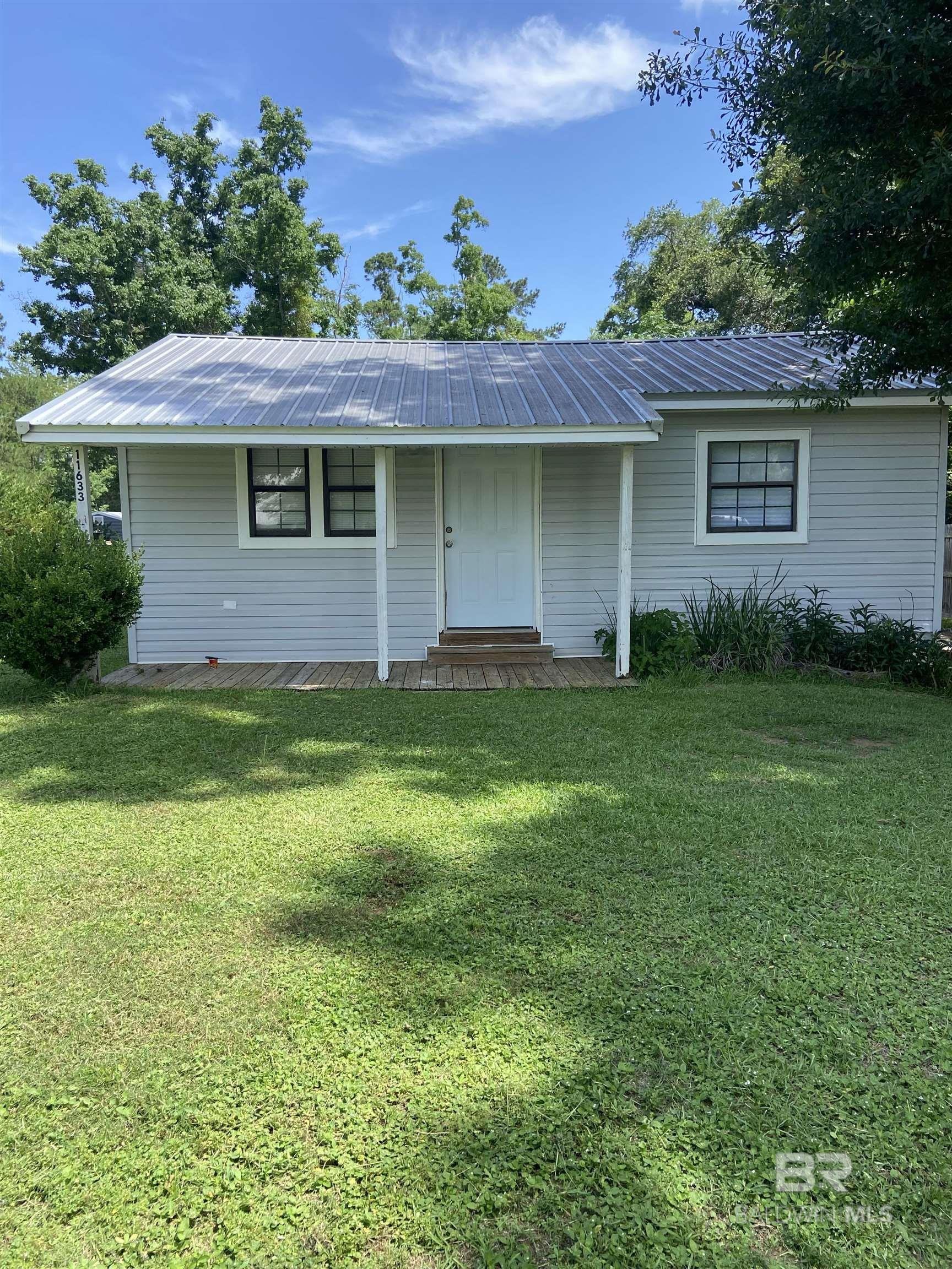 Prime location!  Your chance to get that sought after FAIRHOPE Address.  This cozy quaint cottage is only a short drive to all the dining, shopping, and activities Fairhope has to offer.  Located in the county not the city limits.  Walking into the front door you are greeted with the boasting natural sunlight coming through all the windows. Then walk into the sized kitchen with matching appliances and eat in dining area. Two bedrooms with one and a half bathrooms.  Laundry room right off the master located in the 1/2 bath.  City water, septic tank.  Natural Gas.  Hot water heater replaced 4 years ago.  Metal roof is 5 years old. New HVAC SYSTEM, replaced in 2024!!   Storage shed outside  with power.   Walking outside onto your large back porch there is so much room for entertaining.  There is an abundant amount of yard for gardening, playing, or whatever you wish.  Located in the county..  It had been used as a long term rental..   Owner boast that the cottage had been rented by same tenant for 5 years at $1400.00 per month.   I dare say you could improve that rental price based on a little work and a good eye for some simply upgrades.  Great investment.. 1/2 acre in Fairhope.   Don't miss out on making this home yours. Schedule your appointment today.  Easy to show.   Buyer to verify all information during due diligence.