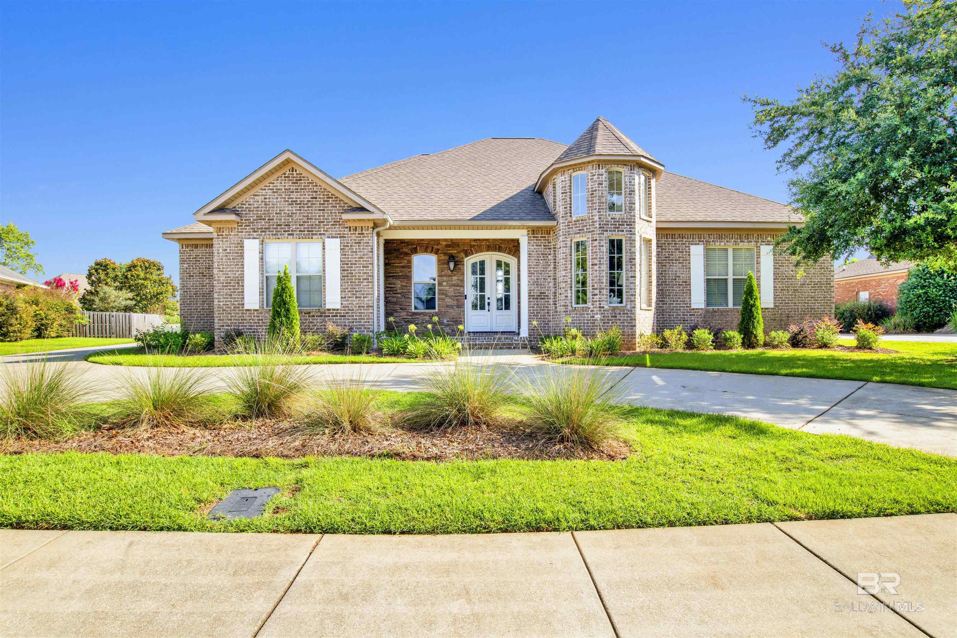 Welcome to this custom home that easily blends elegance and comfort and is a MUST SEE to take in all the extras! Enter through a handcrafted iron ceiling entry and brick archway into a bright, open floor plan with floor-to-ceiling windows that lets in tons of natural light. This home has 12-foot ceilings and 8ft solid wood doors. The state of art kitchen features honed marble counters, dual islands, top-tier appliances, soft close cabinets & Drawers and a walk-in pantry.  The living room has a sweeping peaceful lake views for a serene setting. Your primary suite includes a spa-like bath with claw foot tub and a walk-in closet connected to the laundry room. The 5th upstairs Bonus BR gives guests a private side door entrance, full Bathroom and new stain master carpet.  On top of all this you also have a dedicated office overlooks the front pond and a massive backyard, large enough for a pool. Bellaton subdivision is conveniently located to both Fairhope and Daphne public and private schools, shopping, dining  and has an active HOA that  includes a Community private pool for members.   If you compare this custom built home with others you will quickly recognize the difference in value after examining all the added extras such as ; top tier brand new $35000  Lenox AC/Heat,  2024 remote control garage mini split unit, along with extra attic insulation keeping entire Utilities low & comfortable with no worries about expensive replacement. Brand new security system, whole-house generator, heated/cooled 3-car garage, and new Trane HVAC (Sept 2024).. **following  WILL CONVEY All Tv s 24/ 25 Oled  Samsung Smart TVs, patio furniture & Porch grill which has never been used, includes gas tank, porch table & 6 swivel chairs. Note: DO NOT CONVEY washer/dryer, garage items including shelving, metal cabinets, workbenches, and tool chests. Buyer to verify all information during due diligence.
