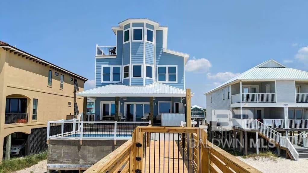 Welcome to Solo Vista, a breathtaking 12-bedroom, 12-bath luxury beach house located directly on the pristine shores of Gulf Shores, Alabama. This spectacular gulf-front estate is a rare find, combining high-end finishes, unrivaled amenities, and sweeping Gulf views from the expansive fourth-floor deck. Designed with both indulgence and entertainment in mind, this fully furnished coastal retreat comfortably sleeps up to 42 guests, making it a rental powerhouse with proven income potential. 12 spacious en-suite bedrooms – each with private bathrooms for ultimate guest comfort. The bathrooms feature designer fixtures and spa-inspired finishes. 3 additional half baths provide added convenience. Relax by the private pool with sun shelf and lounge area for the perfect beachside escape. The expansive deck is complete with a tiki bar for serving up drinks! A private beach walkover provides direct access to sugar-white sands. Hang out in the game room with arcade games, billiards, and more. Have the full cinematic experience after a day in the sun in the private theater with plush seating. The large chef’s kitchen is complete with dual appliances, multiple refrigerators, commercial ice maker, oversized island, and ample seating - perfect for feeding a crowd! The open-concept living & dining areas with floor-to-ceiling windows showcases amazing beachfront views. Whether you’re hosting large gatherings or maximizing rental income, this home was built for entertaining and designed for maximum guest enjoyment. Every detail has been carefully curated to offer the perfect blend of relaxation, recreation, and revenue. Don’t miss this one-of-a-kind opportunity to own one of Gulf Shores’ premier luxury rental properties – schedule your private showing today and experience coastal living at its finest. Buyer to verify all information during due diligence.