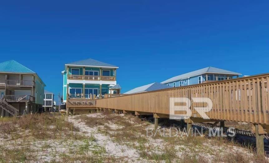 Welcome to Cielo Vista, a breathtaking 11-bedroom, 11.5-bath luxury beach house located directly on the pristine shores of Gulf Shores, Alabama. This spectacular gulf-front estate is a rare find, combining high-end finishes, unrivaled amenities, and sweeping Gulf views. Designed with both indulgence and entertainment in mind, this fully furnished coastal retreat comfortably sleeps up to 40 guests, making it a rental powerhouse with proven income potential. 11 spacious en-suite bedrooms – each with private bathrooms for ultimate guest comfort. The bathrooms feature designer fixtures and spa-inspired finishes. Relax by the private pool and lounge area for the perfect beachside escape. The expansive deck is complete with a tiki bar for serving up drinks! A private beach walkover provides direct access to sugar-white sands. Hang out in the game room with arcade games, billiards, and more. Have the full cinematic experience after a day in the sun in the private theater with plush seating. The large chef’s kitchen is complete with dual appliances, multiple refrigerators, commercial ice maker, oversized island, and ample seating - perfect for feeding a crowd! The open-concept living & dining areas with floor-to-ceiling windows showcases amazing beachfront views. Whether you’re hosting large gatherings or maximizing rental income, this home was built for entertaining and designed for maximum guest enjoyment. Every detail has been carefully curated to offer the perfect blend of relaxation, recreation, and revenue. Don’t miss this one-of-a-kind opportunity to own one of Gulf Shores’ premier luxury rental properties – schedule your private showing today and experience coastal living at its finest. Buyer to verify all information during due diligence.