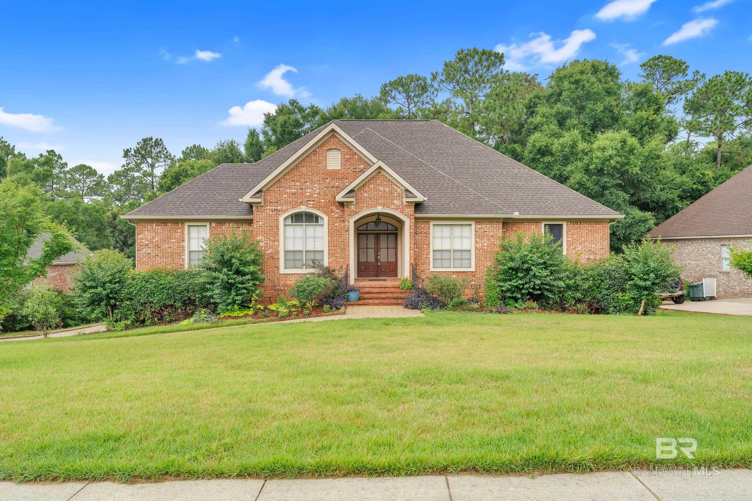 3.75% ASSUMABLE VA LOAN — 4-Bedroom, 4 Bath Home in Timbercreek! Welcome to this great 4-bedroom, 4 bath home with hardwood floors in living areas and primary bedroom.  A beautiful French-door entry leads into the home, where you'll find a flexible space or 4th bedroom with French doors on the right and a formal dining room on the left. The spacious dining area features beautiful molding, a tray ceiling with deep crown molding, and seamless flow into the kitchen. The kitchen is a fantastic gathering area that includes stainless steel appliances, granite countertops, a 6-burner gas range, dual electric ovens, a wine rack, breakfast bar, and a bright breakfast area. The open layout offers clear views into the inviting living room, which showcases built-in shelving, a cozy gas-log fireplace, and additional French doors that lead to the screened back deck with custom roll-down shades.  The primary suite features a turtleback ceiling and an updated bathroom with dual vanities, a jetted tub, separate tiled shower, private water closet, walk-in closet, and ample storage. A spacious lower-level den provides even more room to relax or entertain. Additional highlights include a FORTIFIED roof for added durability and insurance savings, and a TANKLESS hot water heater for energy-efficient, on-demand hot water. Outdoor living is a dream with a walk-out lower-level patio and a  screened deck overlooking a private, wooded backyard.  The side-entry deep double garage equipped with a 240v outlet for charging an electric vehicle gives plenty of space for vehicles. There’s an abundance of additional storage off the garage as well.  This residence perfectly blends wonderful design with comfortable functionality—ideal for both entertaining and everyday living. Property has a Sentricon termite system. Don’t miss your chance to own a great home in the one of the area’s most desirable neighborhoods. Buyer to verify all information during due diligence.