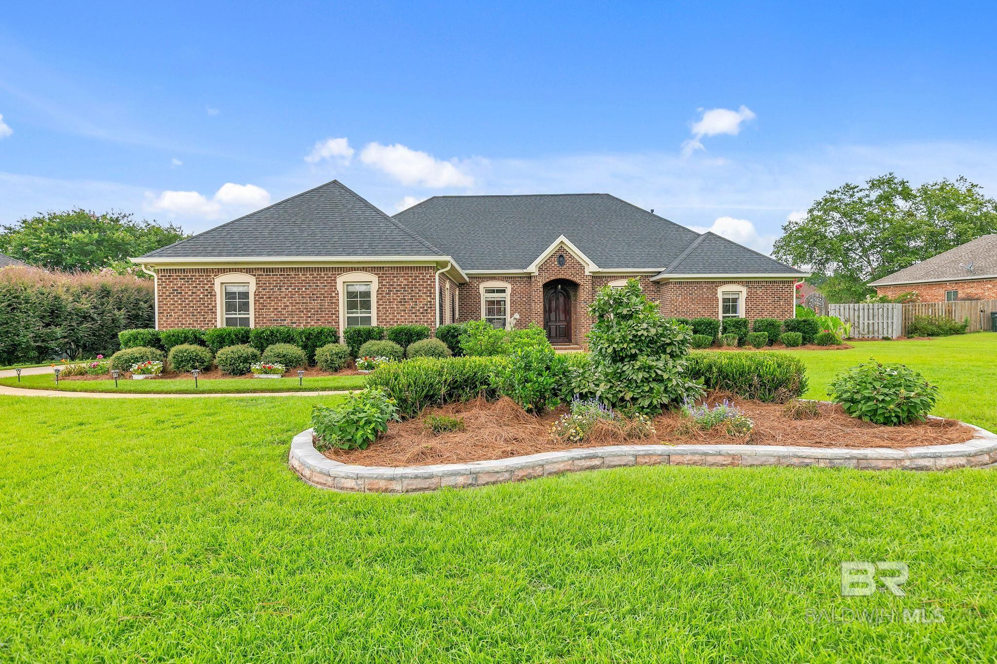 Welcome to Avalon – one of the most sought-after neighborhoods in Daphne! This meticulously maintained 4-bedroom, 3-bathroom home with a separate office offers 2,960 square feet of thoughtfully designed living space, all situated on a generous .60-acre lot. You’ll immediately notice the arched wood front door, the architectural details, soaring ceilings, and abundant natural light throughout. The formal dining room is perfect for special gatherings, while the additional flex space across from it makes an ideal cozy den, music room, or reading nook. The gourmet kitchen is a chef’s dream, featuring an island, granite countertops, newer appliances, a reverse osmosis water filter, a walk-in pantry, and plenty of storage. Granite is carried throughout the home, adding a touch of elegance and durability in every space. The main living area features beautiful hardwood floors and a cozy gas log fireplace, creating a warm and inviting atmosphere. The open-concept floor plan seamlessly connects the kitchen to the living area, making it great for both everyday living and entertaining. The spacious primary suite includes two walk-in closets and a large en-suite bath. Step outside to your screened-in back porch, extended patio, and lush, fenced backyard—ideal for relaxing or hosting. You’ll also enjoy the blackberry bushes - pick fresh berries right at home. The home also features a sprinkler system, and when it’s time to water the yard, no need to worry about the water bill—there’s a WELL! Additional highlights include a newer fortified roof (2021), tankless gas water heater (2022), gutters, EV charging station, the refrigerator, washer and dryer are all included, and a WHOLE HOUSE GENERATOR, providing added comfort and peace of mind year-round. Don’t miss the opportunity to live in this beautiful home that truly has it all! Buyer to verify all information during due diligence.