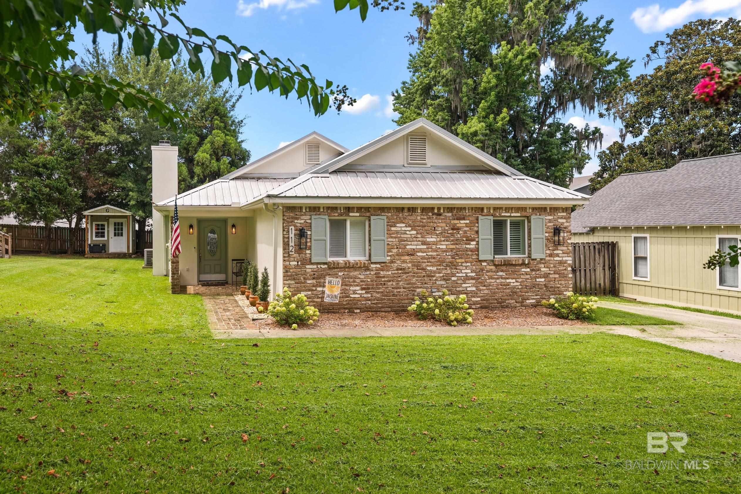 If you are looking for a remarkably well kept home in a remarkably wonderful location in Old Town Daphne, this is it.  Located in the first block up from the bay, you will find this opportunity... well remarkable! The home is close to the bay. It's charming with an updated metal roof, recent painting and new HVAC in 2019.  New quartz countertops, new plumbing throughout, tankless water heater, new appliances in 2022.  The home has two living areas.  The main living area has a fabulous fireplace and vaulted ceiling and flows into the kitchen.  The second living area is spacious with built in shelving and storage.  The current owners are configuring it as a 3rd bedroom in addition to a living area. The home has Plantation Shutters throughout and a fenced back yard.  A great deck and large screened porch is accessed by French doors, located just off the kitchen and dining area.  This home would be a perfect home for anyone wanting one floor living on one of the most iconic streets in Daphne, a second home or a short/long term rental.  Old Town Daphne is a special place to live with easy access to shopping, restaurants, schools including Bayside and of course... the bay.  When you walk inside, you're going to be impressed! Agent is related to the seller. Buyer to verify all information during due diligence.