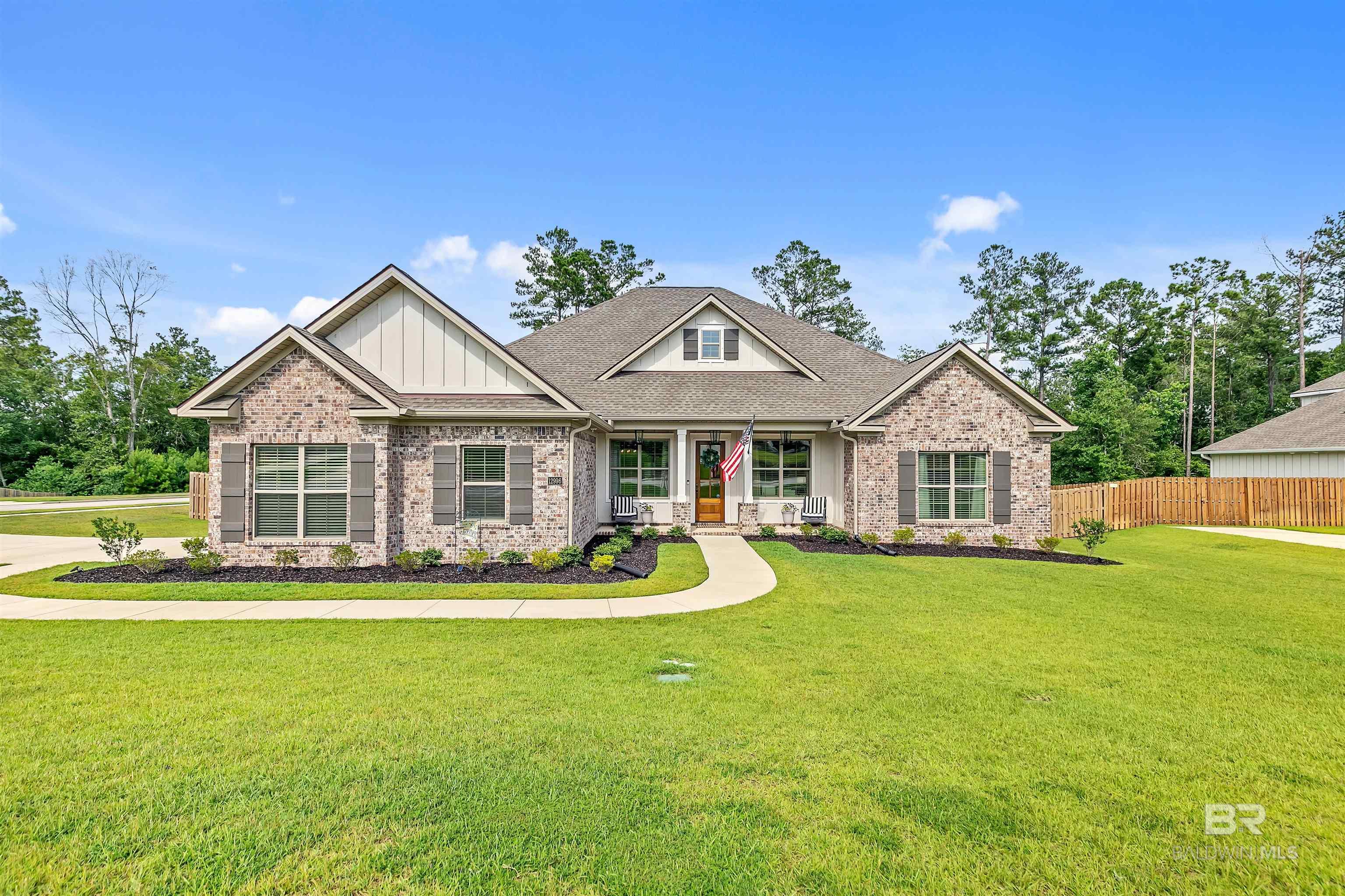 Better than new and Gold Fortified, this beautifully upgraded 5-bedroom, 3-bath Truland-built home sits on a spacious corner lot backing up to trees in  Stonebridge neighborhood. Just a one-minute walk to the Monticello amenities, this home offers privacy, space, and a thoughtful layout with high-end finishes throughout. Step inside to find wood flooring, updated lighting throughout, and custom window coverings, including real wood 2.5” blinds and insulated cordless cellular shades. The open-concept kitchen features quartz countertops, gold fixtures, a filtration faucet for purified water, a large walk-in pantry, and extended custom cabinetry to create a built-in coffee bar. The laundry room is also upgraded with quartz countertops, a deep sink, and additional built-in cabinetry.The primary suite offers a spacious retreat with a spa-like bathroom, including double vanities, a deep soaking tub, a large walk-in shower, and a custom walk-in closet with built-ins. Bedroom 2 is located at the front of the home with barn doors, making it ideal as a home office or guest space. Bedrooms 3 and 4 each have walk-in closets and are connected by a Jack and Jill bathroom. Bedroom 5 is privately situated with its own walk-in closet and a full bathroom conveniently located nearby, perfect for guests or multigenerational living.Additional upgrades include smart home technology, a garage storage system with overhead racks and a FastTrack wall system, whole-home rain gutters, and a shadowbox privacy fence with double gates. A screened-in back porch overlooks the large backyard, and a welcoming front porch adds to the curb appeal.Stonebridge offers resort-style pools, fitness center, tennis courts, basketball courts, soccer fields, playground, whiffle ball field, golf cart-friendly, and annual community events such as an Easter egg hunt, fall festival, and the popular Witches Ride. This home is truly move-in ready and better than new! Buyer to verify all information during due diligenc