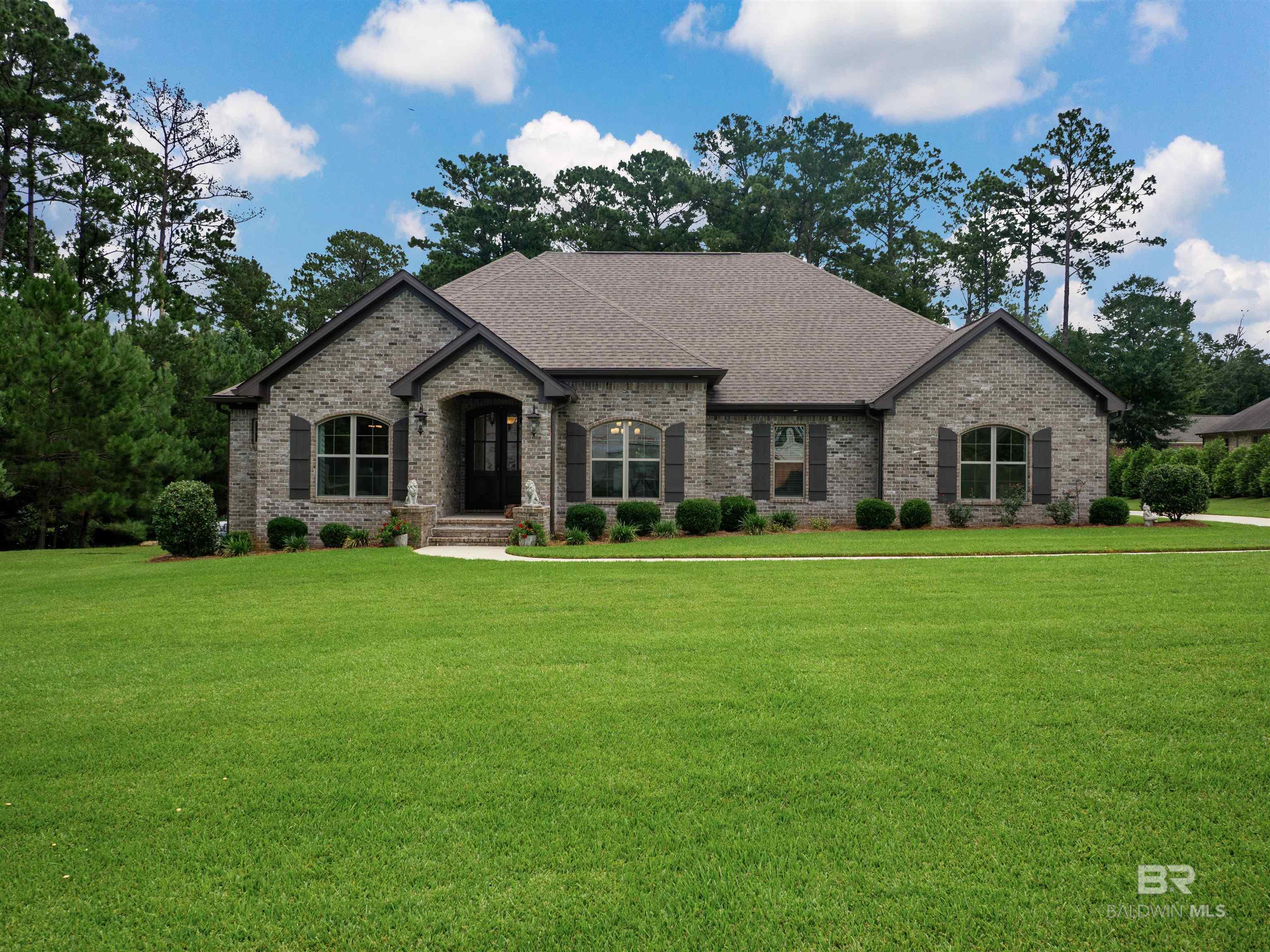 Discover the perfect balance of privacy and convenience just minutes from Malbis Emergency Care, shopping, dining, I-10, the Bayway, and Causeway in this stunning 4-bedroom, 3.5-bath home. It offers 3,049 sq. ft. of thoughtfully designed living space on nearly 1.5 acres of lush, landscaped grounds. From the moment you arrive, the long driveway and multiple parking spaces set the tone for the space and comfort this property provides. Step inside to a Gold Fortified, open-concept layout with abundant custom trim work, soaring ceilings, and natural light that fills every room. A separate dining room makes hosting easy, while the spacious bedrooms provide room for everyone. The chef’s kitchen features granite counters, premium finishes, and flows seamlessly into the living area—ideal for gathering with friends and loved ones. The primary ensuite boasts a spa-like bath and a custom closet with built-in dressers for ultimate organization. Outside, enjoy your own beautiful backyard oasis: a screened patio, an outdoor grilling station with masonry fireplace, and a walking trail that winds through fruit trees, berry bushes, and a garden with running water. A pet washing station adds convenience for animal lovers, while the lush landscaping offers peace and privacy year-round. Practical upgrades include a whole-house generator, security camera system, gutters with in-ground drainage, a 22k power setup, and a storage shed with electricity and is on slab. Whether you dream of entertaining under the stars or enjoying quiet evenings by the outdoor fireplace, this home makes it possible. If you’ve been looking for a home that feels like a retreat but keeps you connected to everything you need, this is it. Tucked away for privacy yet—this property offers the best of both worlds. Buyers and/or buyer’s agent are to verify all measurements, square footage and anything material to the buyer(s) in deciding to buy this home. Buyer to verify all information  Buyer to verify all informatio