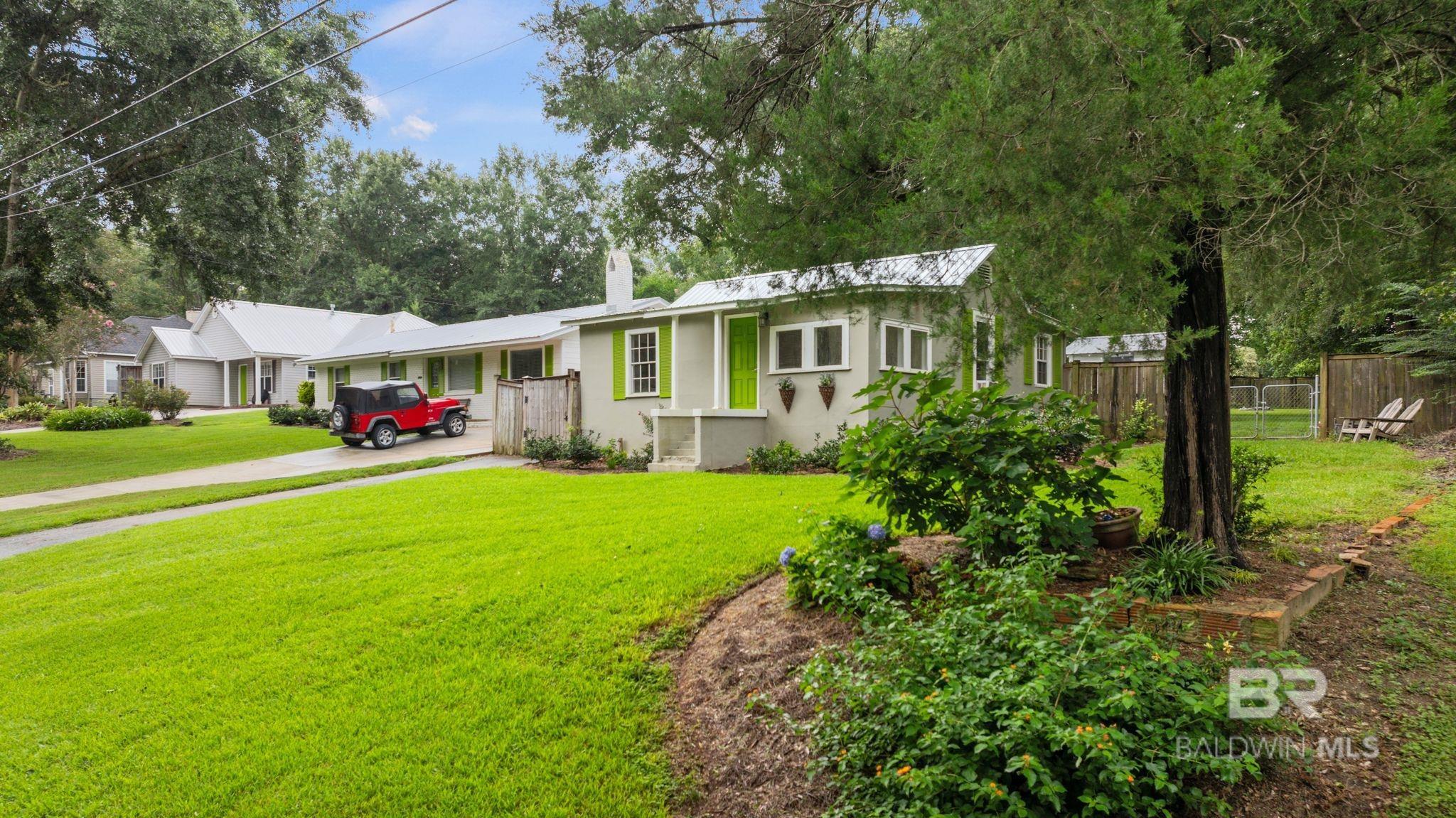 Opportunity awaits near downtown Fairhope. This adorable cottage built in 1934, offers two bedrooms, one bathroom and tons of character. The beautiful spacious lot is located less than a mile to the center of town and is just  a block from retail shops, salons, The Coffee Loft and Ben's BBQ. The metal roof, AC ductwork and hot water heater were replaced last year. This home is being sold as-is and is ready for your vision and updates. Don’t miss this chance to own a home in a prime location. Call today & schedule a showing. Buyer to verify all information during due diligence.