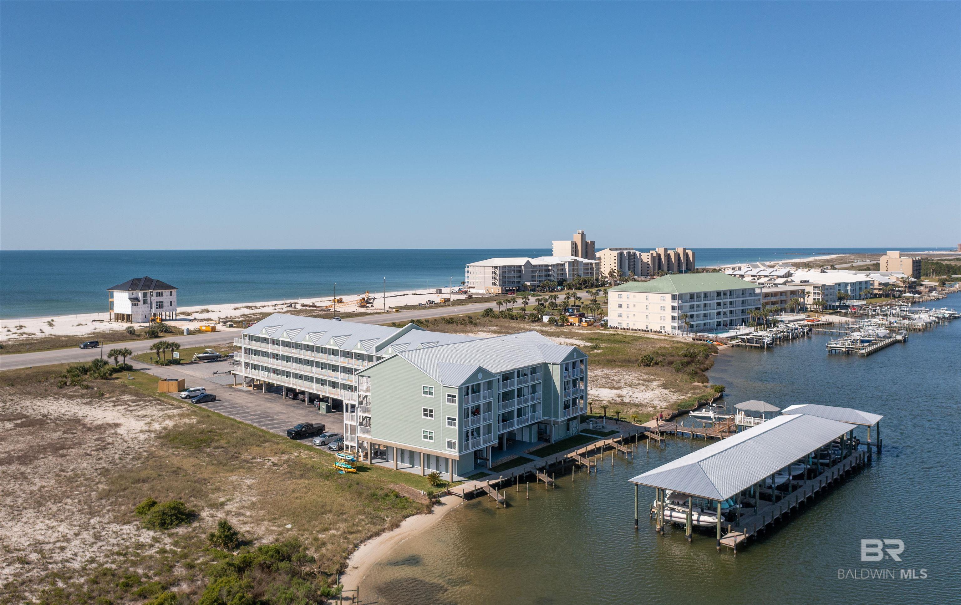**Seller offering $2500 in seller concessions at closing if sale takes place by 12/31/25 or before, sale must take place by end of 2025**.Don't fight the crowds of a large complex! Jubilee Landing offers a smaller intimate community where you can relax and enjoy being at the beach and condo living without large crowds!! Unit 210 has the best of ALL worlds! From direct water access to Old River, first come first serve boat slips, deeded storage closet that conveys with sale, covered vehicle parking for owners, an outdoor pool, BBQ & picnic area, gazebo, fishing pier, unobstructed views of both Old River and the Gulf of America, private large balcony, and a short 0.5 mile walk to Shell beach...this property meets all the criteria! Have a boat? Then this complex is perfect for you! Not only do owners have access to first come first serve boat slips, they also have a designated area for boat trailer parking (owners only). With quick access to Robinson Island and the gulf, you can have both an enjoyable day on the islands as well as access to the deep waters! This gorgeous unit features new paint throughout the unit, new living room furniture, new living room/dining lighting fixtures, new upholstery on the bar stools/dining room chairs, a new living room rug since 2023, beautiful white quartz countertops, and spacious bedrooms to accommodate up to 6 guests for rentals. What also sets Jubilee Landing apart is only being 0.5 miles from Flora-Bama and Flora-Bama Yacht Club, where you can enjoy being close to events such as the Mullet Toss and all the nightlife these venues have to offer! Whether you're looking for a 2nd home or investment property, this unit is the perfect opportunity! This complex will provide perfect bayside living! Buyer to verify all information during due diligence. Seller offering $2500 toward buyer's closing costs/prepaids with acceptable offer!!