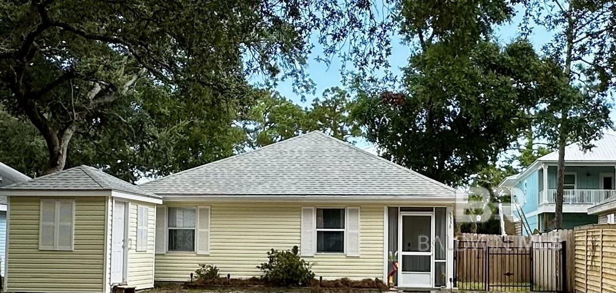 Bring the boat and immerse yourself in the breathtaking beauty of beach living in this adorable coastal cottage with a water view! With this home nestled at the end of Bay Drive in Orange Beach, AL, you can enjoy the tranquility of small town life with all the fun of the Gulf minutes away, and Wolf Bay only steps away. An updated kitchen, fresh paint, and ceramic tile throughout, make this property easy to maintain. The fenced-in backyard features a partially enclosed porch for outdoor entertaining. With a free-standing storage building for beach gear, tools, or bikes, you still have room to bring your golf cart, allowing you to enjoy the relaxed pace of island life. If you have a boat, this neighborhood has no HOA, but owners can opt into the local POA for only $300 annually to have access to the members-only boat launch, docks, beach, and covered picnic areas. THERE ARE THREE WATERFRONT MEMBERS' ONLY AREAS FOR YOU TO USE AND ENJOY! This would make a great weekend retreat or year-round residence where kids can ride bikes to school and fish all afternoon. Whether you're exploring the vibrant local scene or simply relaxing on pristine beaches, this property offers the perfect blend of quiet convenience and seaside charm. This home was built in 1996 and has never flooded!!! Easy to show, so don't hesitate to check it out! Buyer to verify all information during due diligence.