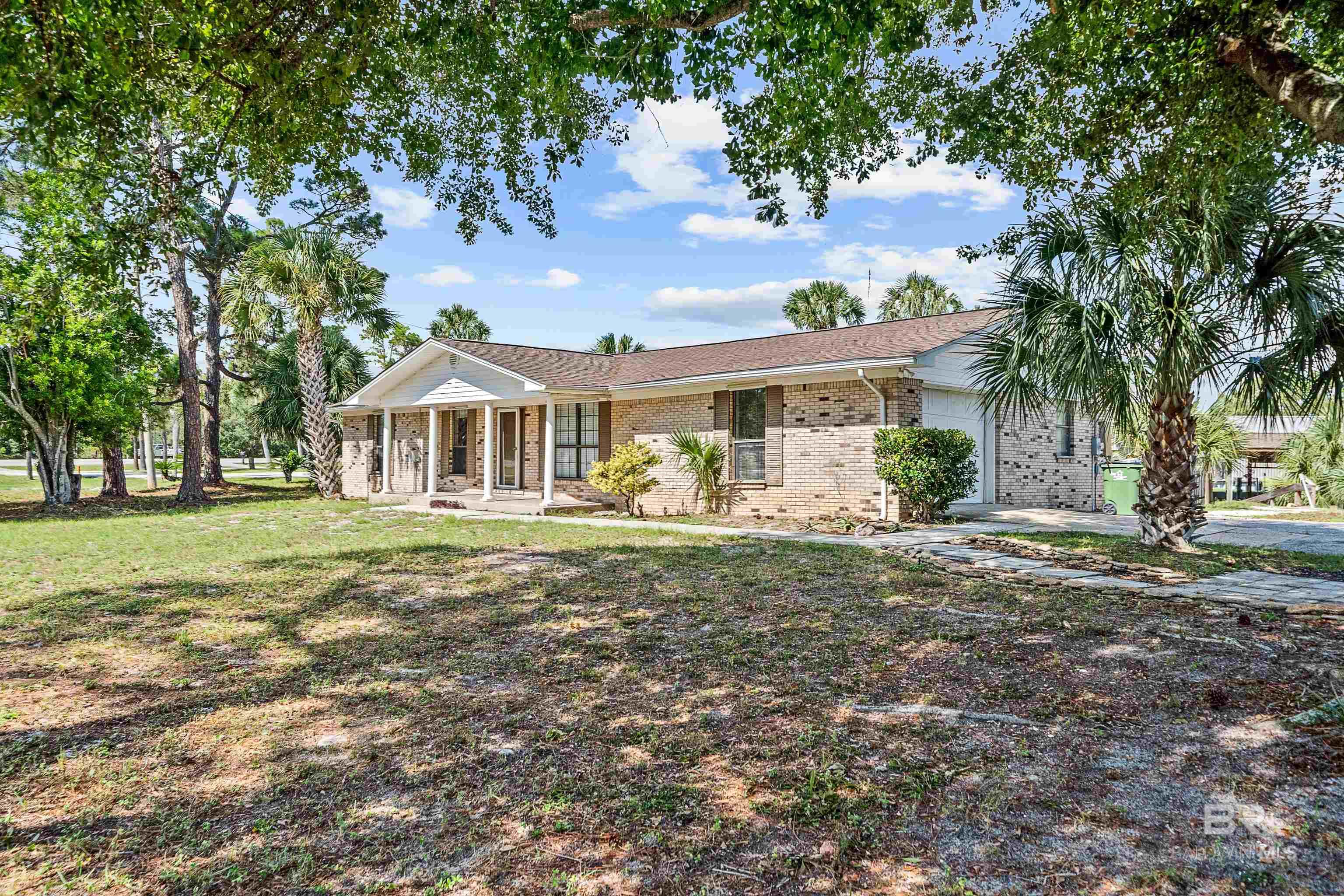 Boaters, beach lovers, and outdoor enthusiasts will feel right at home at 26063 Marina Rd in the heart of Orange Beach. Set on a rare .76-acre corner lot at AL-161 and Marina Rd with no HOA, this property is a dream for avid boaters, offering a covered boat slip with lift plus a basin that can accommodate two additional large vessels. From this prime spot in Terry Cove, you’ll enjoy unmatched opportunities for outdoor recreation—hop on your boat right from your backyard, access the Backcountry Trail directly across the street, or spend the day on the white-sand beaches less than two miles away. Just minutes from your door, you’ll find waterfront dining, shopping, and entertainment that make this location as lively as it is scenic. This 3-bedroom, 2-bathroom brick home with sunroom, featuring a roof replaced within the last two years, also includes a fenced backyard with storage shed. Inside, the kitchen and bathrooms feature granite countertops, and you’ll also find a dedicated laundry room and single-car side-entry garage. While the home is ready for your personal touch, the possibilities are endless with this oversized lot and unbeatable water access. Whether you envision renovating to create a modern coastal retreat or simply enjoying the boating lifestyle it already provides, this property presents a rare opportunity to own canal-front living in one of the most sought-after areas of Orange Beach. Buyer to verify all information during due diligence.