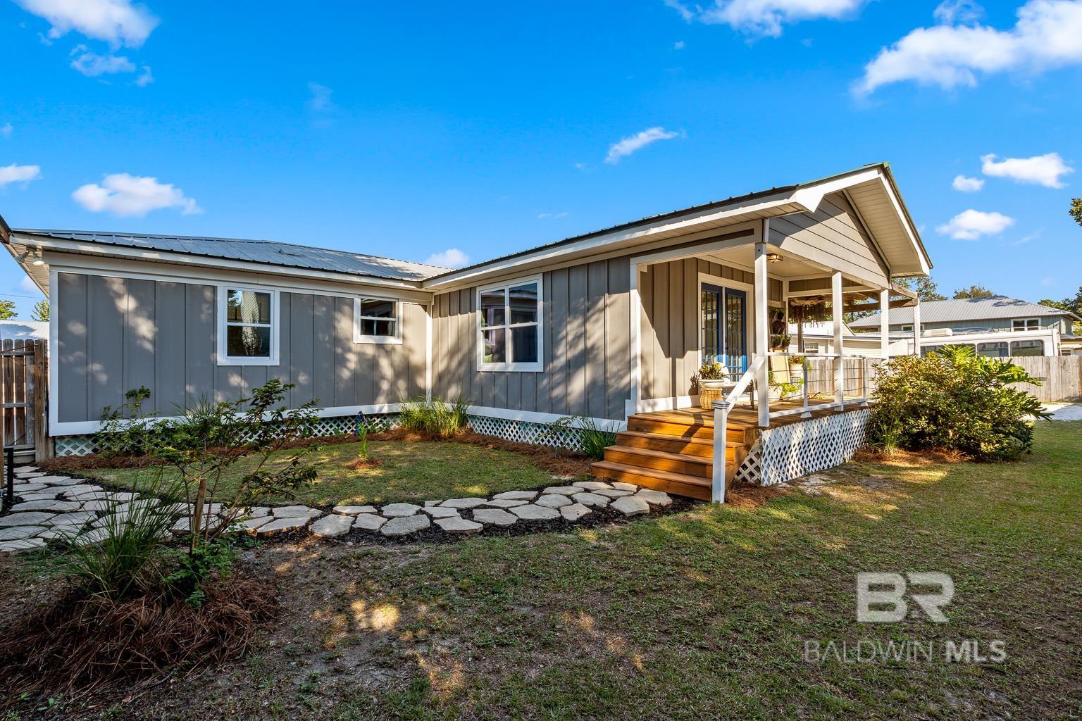 SELLER OFFERING UP TO $10,000 IN BUYER CONCESSIONS WITH ACCEPTABLE OFFER.Welcome to 5328 Pensacola Avenue, where coastal comfort meets timeless charm in the heart of Bear Point Estates. This beautifully maintained 4-bedroom, 3-bathroom home with a large bonus room sits on two full lots, offering exceptional space and privacy rarely found in the neighborhood. Positioned on high elevation, the home requires no flood insurance and sustained no damage during Hurricane Sally—a true testament to its strength and craftsmanship.Inside, you’ll find a warm and inviting layout that feels both open and intimate. Natural light fills the living areas, while the split-bedroom design provides comfort and flexibility for families, guests, or a home office. The home features two primary bedrooms, each with a private bathroom—ideal for multi-generational living or hosting with ease. Every space has been thoughtfully updated and exceptionally maintained in a smoke-free, pet-free environment, making this fully furnished, move-in ready home an easy choice for full-time residents or second-home buyers.Step outside to your private backyard oasis with a covered grilling porch, Big Green Egg setup, outdoor sink and prep station, hot tub, and lush landscaping with accent lighting. A detached workshop with golf cart parking completes the space—perfect for enjoying the active, golf cart-friendly lifestyle Bear Point is known for. Roof is approximately 12 years old, and the HVAC system (2014) was recently serviced with a new motor and bearings.Located just .55 miles from Arnica Bay and the Bear Point Community Center, residents enjoy access to a private neighborhood beach, pier, playground, picnic areas, and outdoor showers. Bear Point offers a voluntary HOA at $300 annually. OSO at Bear Point Harbor, The Dock Store, and the community boat launch are just around the corner. 5328 Pensacola Avenue captures everything coastal. Buyer to verify all information during due diligence.