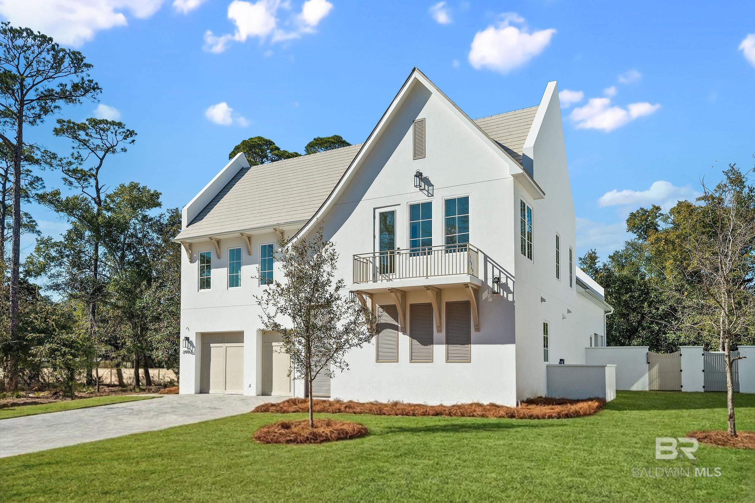 Welcome to coastal luxury reimagined! Tucked away in a private, gated bayfront community, this thoughtfully designed residence showcases clean coastal lines, luxury living, water views, and an open-concept layout for entertaining and serene everyday living. Inside, you'll find high-end finishes throughout, a spacious kitchen with custom cabinets and premium Thermador appliances, a luxurious primary suite on the ground floor, a laundry room on the main floor plus extra laundry hookups in two of the upstairs guest bedrooms, an additional living room/bonus space upstairs, engineered hardwood and tile flooring, 16’ coffered ceiling in the living room, custom closets, paver driveway, and so much more. The living room opens to the covered back porch that is setup for relaxation and entertaining with a gas grill and gas fireplace. The 10x20 saltwater pool is perfect for cooling off on those hot summer days. This home is built to last with ICF concrete construction, and it is Fortified Gold. X Zone (flood insurance not required)! Moondance is a new charming waterfront community on the beautiful shores of Perdido Bay in East Orange Beach. Filled with natural beauty, this unique community offers a peaceful setting, impressive heritage oak trees, a large common area pier, and beautiful sunrises - just minutes from white sandy beaches and so many great dining options. Home is under construction and projected to be complete in December of 2025. Virtual renderings are provided as examples. Builder reserves the right to make changes and substitutions. Buyer to verify all information during due diligence.