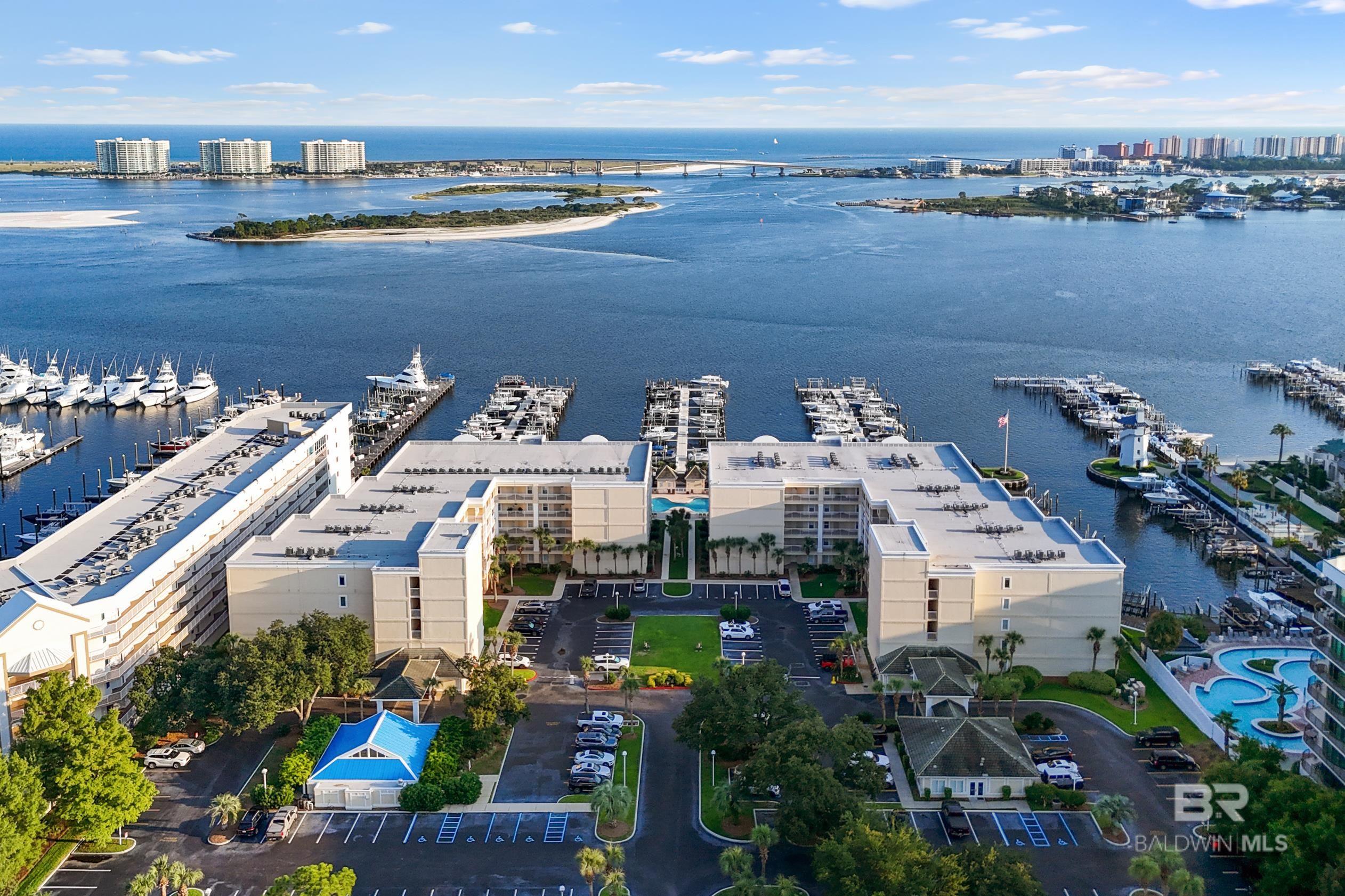 Perdido Grande offers this exceptional 4 bedroom and 3 full baths condo with all the amenities.  Private boat slip to accommodate a 20’ beam and 47 ft. long boat and No 77.  Solid surface counter-tops, all appliances, side porch with views of Terry Cove.  Unit comes fully furnished.  The complex has an array of amenities to include indoor and outdoor pools, work-out room, tennis courts, and private beach area. Buyer to verify all information during due diligence.