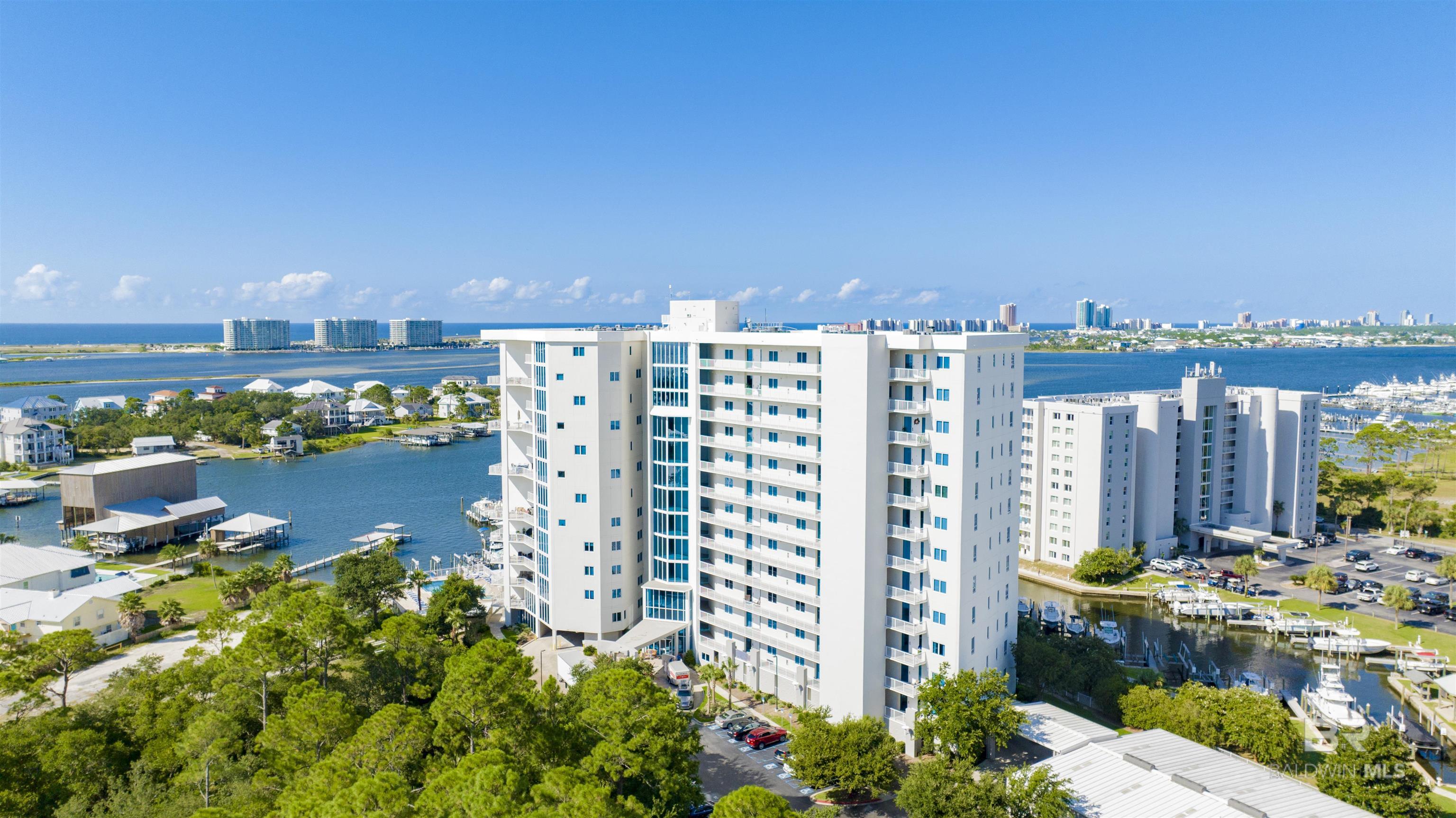 Stunning water views, overlooking Terry Cove and the islands all the way to the bridge and the Gulf!  This 3BR/3BA condo in the coveted Bayshore Towers features a spacious open floor plan with 10' floor-to-ceiling glass in the main living area and primary bedroom, offering views of passing boats by day, and city lights at night.  Enjoy incredible sunsets across the water from the expansive 32' balcony with a plumbed stainless gas grill.  The kitchen boasts granite counters, high-end stainless appliances and refrigerator with custom craft ice, designer backsplash and premium lighting.  All bedrooms are tastefully furnished and spacious, have ensuite bathrooms, custom plantation shutters, and closets with custom built-ins.  There is also a bonus room that can be used for an office, studio or bunk room.  The condo features motorized shades, a gas fireplace, LED lighting, new flooring in the bedrooms, and newer HVAC. The 7+ acre property is gated, with lush manicured landscaping, 2 tennis/pickleball courts, 2 outdoor pools/spas, wooded park, exercise rooms, common room with wet bar, and a new marina with deeded, as well as first-come first served slips.  There is on-site management and a minimum 60-day rental restriction - no vacation traffic to deal with.  A MUST SEE!  Buyer to verify all information during due diligence.