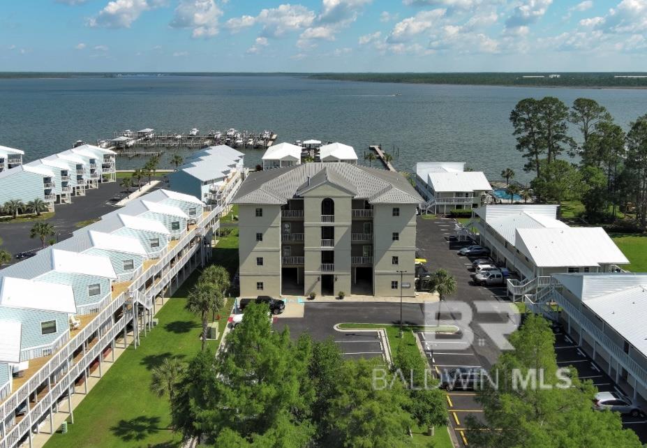 ***DEEDED BOAT SLIP*** Come and experience breathtaking views, and unforgettable sunsets over Wolf Bay and the Intracoastal Waterway from this beautifully maintained, move-in ready, 2 bedroom 2 bathroom unit on the top floor of Bay Towers! When you enter to door, you're immediately in awe of the tall ceilings, open concept, and clean feel of this stunning condo. The kitchen features granite countertops, stainless appliances, new backsplash, and a convenient eat at bar. The cabinets are a gorgeous solid, warm wood and offer plenty of storage. The kitchen opens to the spacious living and dining area both of which have sliding glass doors that lead out to a generously sized covered balcony that looks out over the pool and bay.The complex offers luxuries such as a private pool, BBQ area, storage room, bike and paddle board storage, and private golf cart parking with charging outlets. The building has an elevator and onsite ice machine for your convenience too! What more could you ask for??!! Make your appointment to see this one today!  Buyer to verify all information during due diligence. Up to $20k in seller concessions!