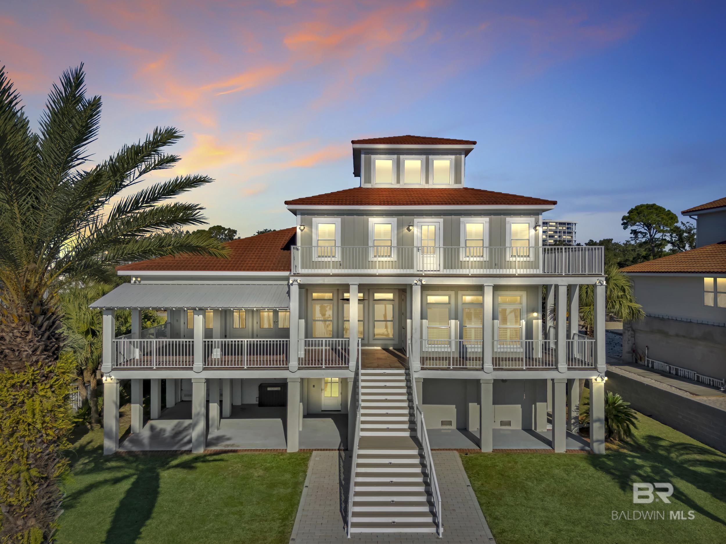 Very rare opportunity on deep, open water with easy access to Perdido Pass and the Gulf of Mexico! Luxury abounds in this one-of-a-kind coastal retreat where no detail has been overlooked. This expansive 4-bedroom, 4-full and 2-half-bath home (potential for 5th bedroom) is set on a beautifully landscaped lot with approx. 90 ft of waterfront on Bayou St. John and features a new deep-water boat dock with slip. Enjoy real wood floors, custom crown molding, and a third-floor observation room offering 360° views of Terry Cove, Johnson Cove, and the Gulf. Impact windows and doors throughout. Spacious bedrooms include a private en-suite and balcony with stunning water views. The elegant wood-paneled elevator accommodates multiple passengers and is handicap accessible. A bonus room with vaulted wood ceiling and arched window enhances the coastal character. The chef’s kitchen boasts imported Brazilian white marble counters, under-counter wine cooler, abundant prep space, and breathtaking water views—ideal for gatherings or entertaining. The 3300 sq ft., 6-car heated and cooled garage offers epoxy floors, half bath, extensive storage, space for rod room, boats, and in-home gym. Step outside to enjoy waterfront activities, outdoor shower, and reinforced bulkhead. The first-floor primary suite features a Bain Swedish spa tub, multi-head shower with exceptional water pressure. Additional highlights include a formal dining room (or study), custom “Birds of Paradise” wrought iron staircase, central vac system, and dedicated laundry  and cleaning closet with utility sink. A true coastal masterpiece built for comfort, elegance, and the ultimate waterfront lifestyle. Buyer to verify all information during due diligence.