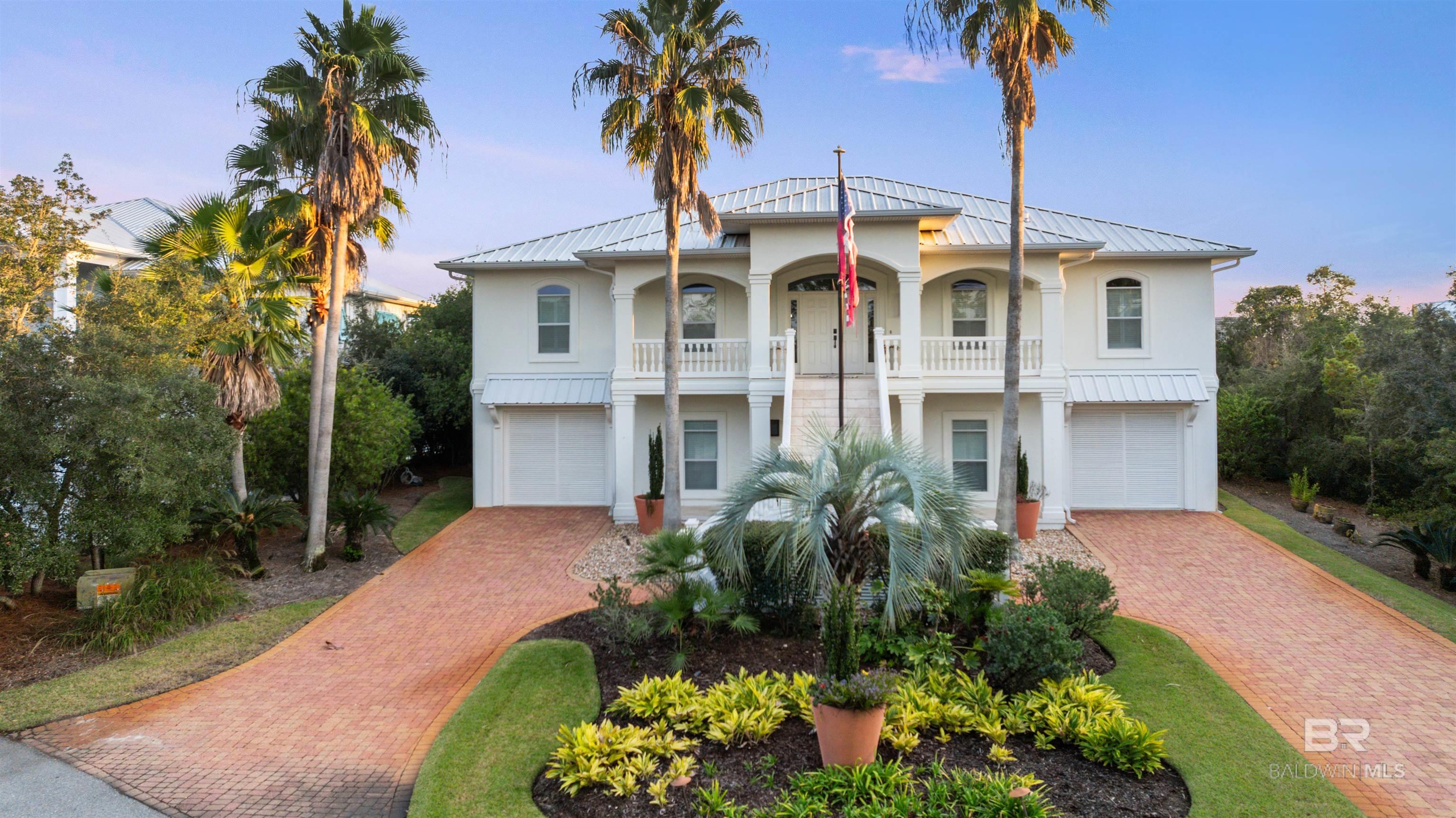 Stunning canal-front home on highly sought after Ono Island! This fully furnished 5-bedroom, 4-bath residence offers 4,326 sq. ft. of exceptional coastal living on beautiful lot at the end of a private cul-de-sac. The home conveys fully furnished with brand-new furniture, making it move-in ready.Enjoy easy access to big water from your private canal-front setting— a prime spot for boating and waterfront relaxation. The property includes a private boat dock and lift offering effortless access to the water. An exterior elevator/lift provides convenient access to every level of the home. Upgrades include three recently installed HVAC units, a brand new hot water heater and a whole-house gas generator for ultimate comfort and peace of mind.The outdoor living spaces are truly exceptional. The inground pool is surrounded by generous patio space with a flexible area that could be used for sunbathing, entertaining, or simply enjoying the peaceful waterfront backdrop. The home features two covered patios—one on the main level and one on the upper level—both overlooking the canal, offering multiple places to dine, relax, and take in the coastal breezes and scenic views.  A private irrigation system adds convenience and helps maintain the beautifully kept grounds year round. Inside, the spacious layout includes multiple living areas, beautiful hardwood and tile flooring, oversized bedroom suites and flex spaces, and an abundance of natural light throughout.  Beautifully maintained and loaded with premium features, this Ono Island property offers privacy, luxury, and effortless waterfront living. Buyer to verify all information during due diligence.