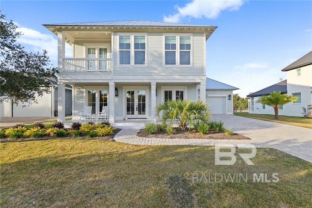 Stunning New Construction on Exclusive Ono Island—Gold Fortified by Elite Homebuilders! Welcome to 30313 River Rd, a custom-built coastal home in one of Baldwin County’s most prestigious gated communities. This spacious residence offers two primary ensuites—one upstairs and one downstairs—ideal for multigenerational living or hosting guests. The upstairs suite is exceptionally large with space for a sitting or media area, plus an oversized walk-in closet with custom built-ins. The downstairs suite also features a generous custom closet and a spa-style bath. Both ensuites include walk-in showers and relaxing soaking tubs, and the main-level suite boasts elegant tray ceilings. The home showcases one-of-a-kind designer tile throughout, modern lighting, and an airy open-concept great room perfect for entertaining. The chef’s kitchen features Café white-and-gold appliances, custom cabinetry, and a large island. A convenient half bath serves guests, and TWO laundry rooms—one on each floor—add everyday ease. Step outside to a large covered porch with an outdoor kitchen overlooking a deep backyard with plenty of room for a pool. All window treatments throughout the home are crafted from natural materials, including bamboo and cotton, adding warmth and organic texture to every room. Additional features include impact-rated windows and doors, engineered Blanca oak hardwood flooring, 7-inch crown molding, 10-foot ceilings, 8-foot doors, fully cased windows and doors, a double garage, and a paver driveway. Ono Island residents enjoy 24/7 gated security, a private boat launch, tennis courts, playgrounds, sidewalks, a recreation center, and unmatched privacy. This is a rare opportunity to own a brand-new custom home in one of Alabama’s premier island communities. Schedule your private showing today! Listing agent makes no representation as to square footage accuracy. Buyer and Buyer’s agent to verify all information. Buyer to verify all information during due diligence.