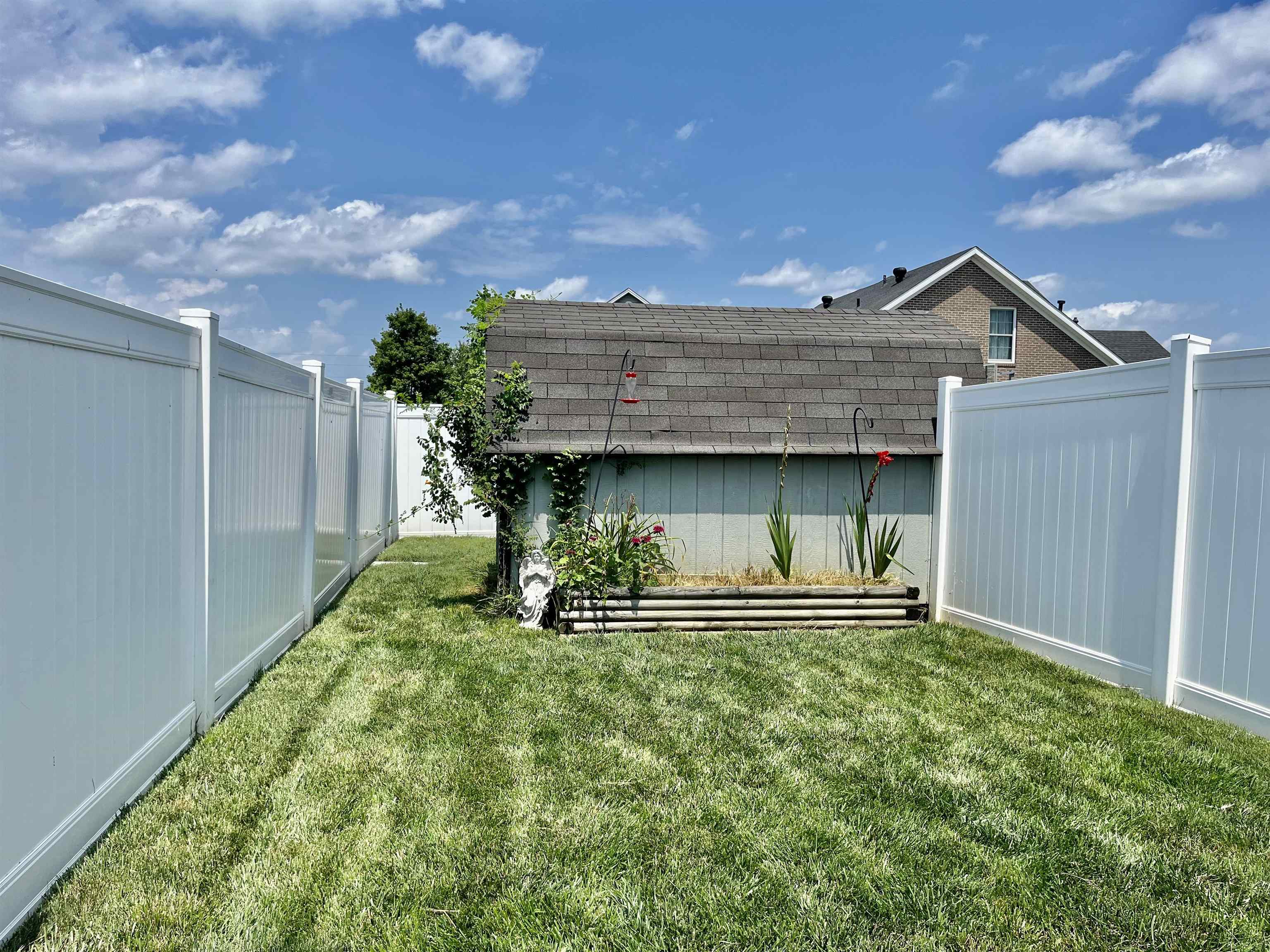 6 foot vinyl privacy fence. More yard behind the storage building.