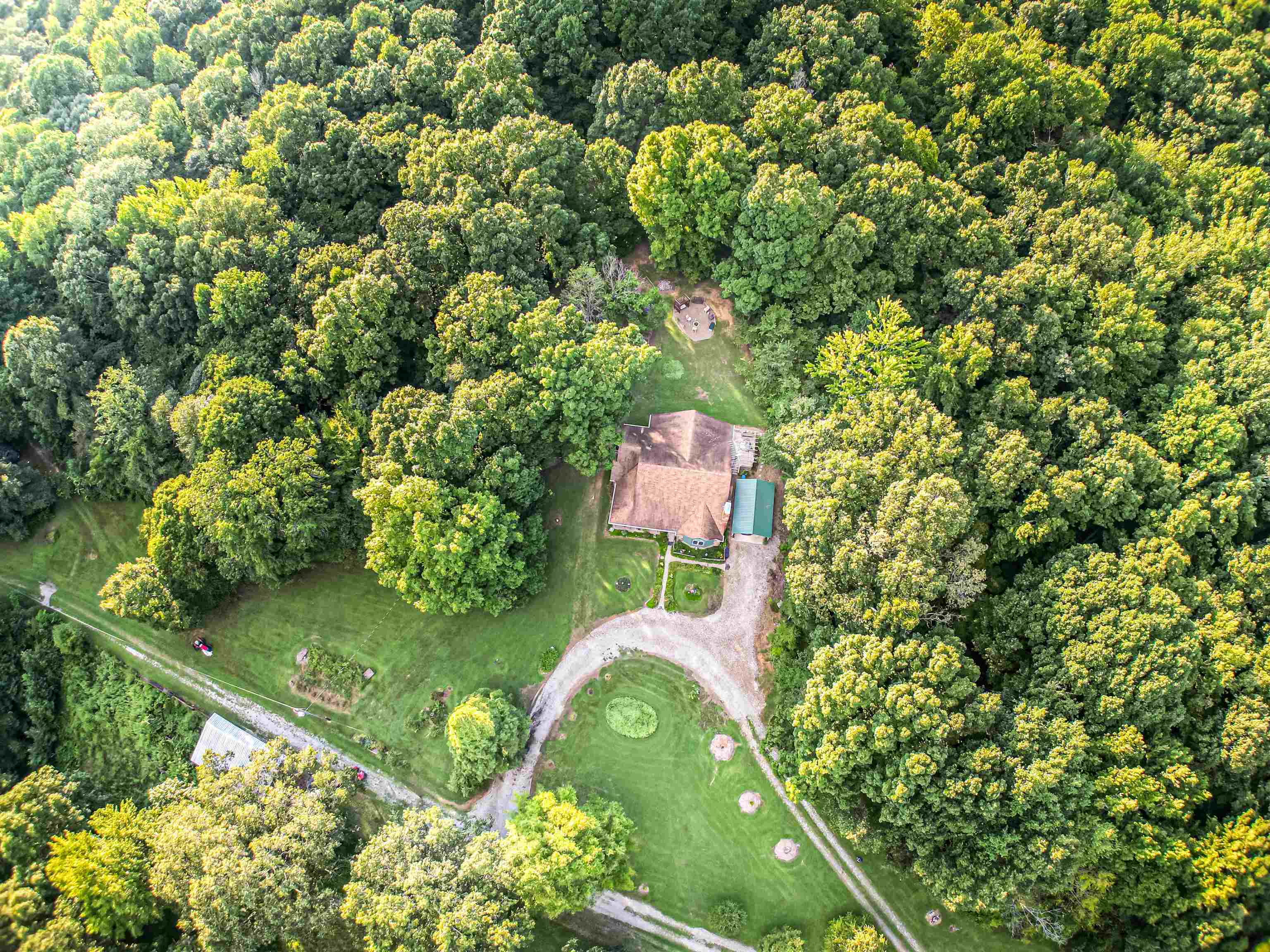 Check out the wooded area behind the house as well as the pasture and lake in the front!
