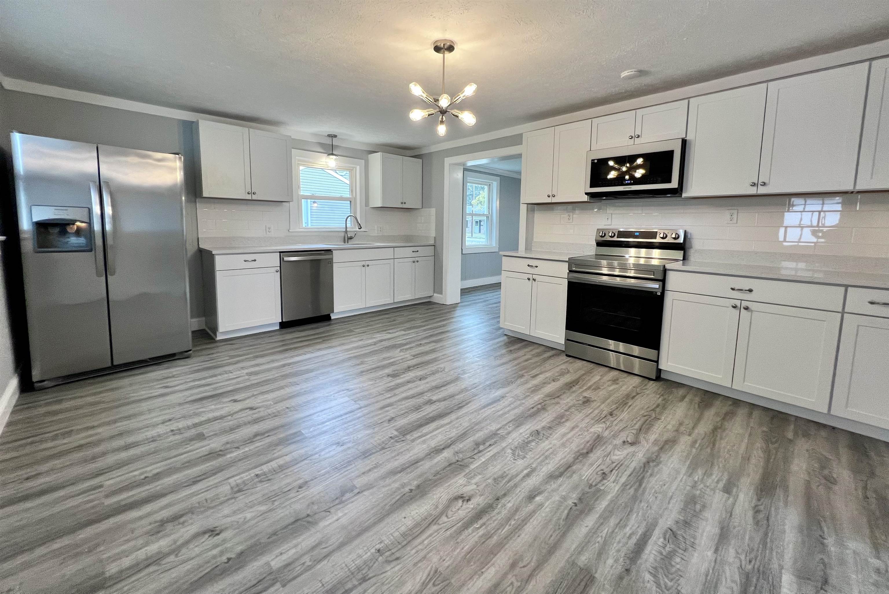 Remodeled kitchen with new cabinets, granite, tile backsplash & stainless steel appliances
