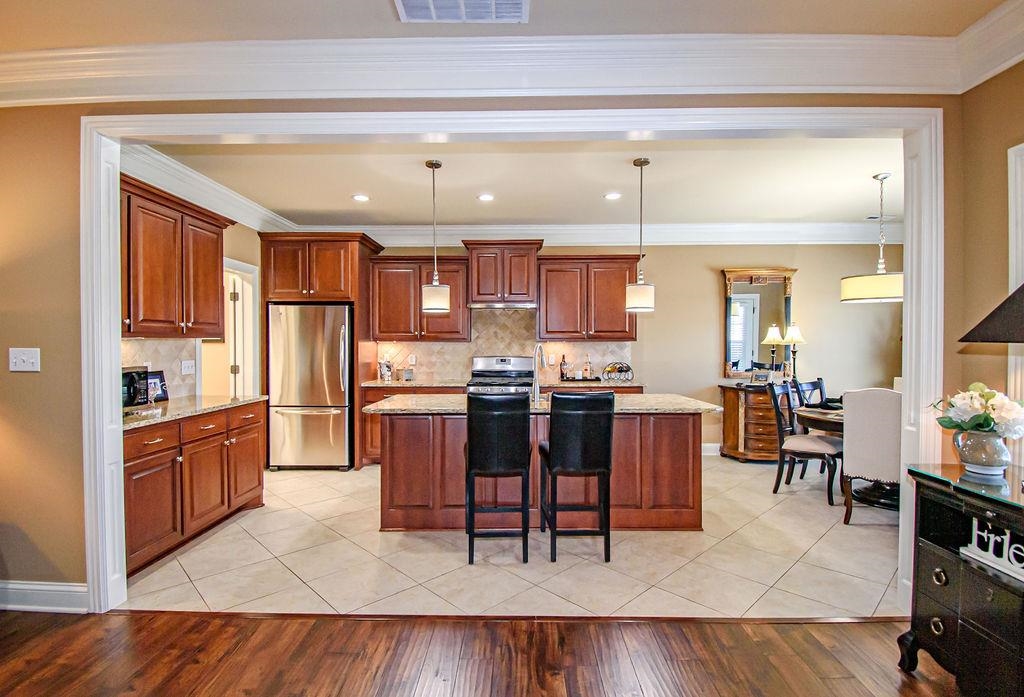 Gourmet kitchen features custom cabinets, stainless appliances, crown moulding, granite tops!