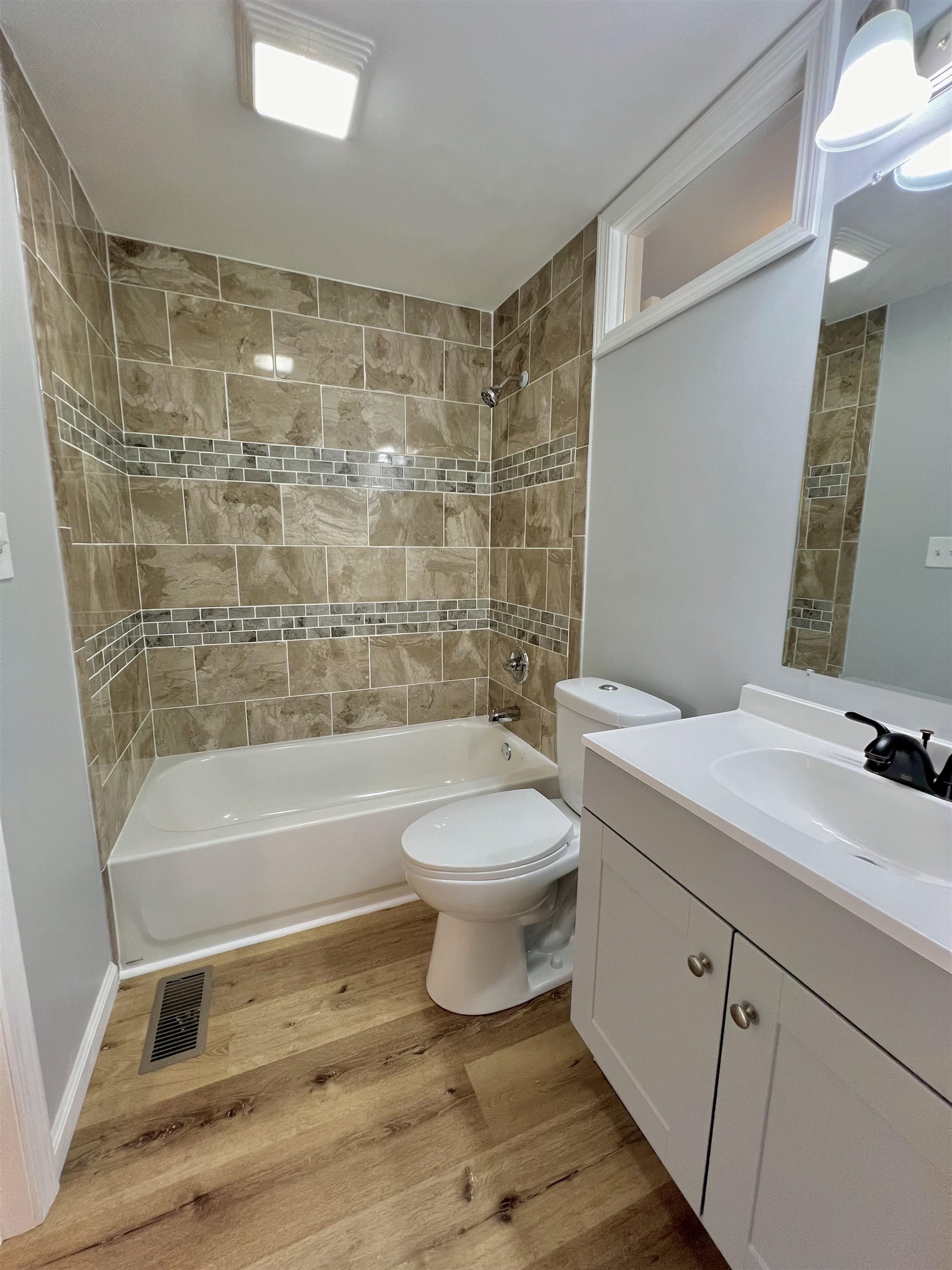 New tiled tub/shower, toilet and vanity.