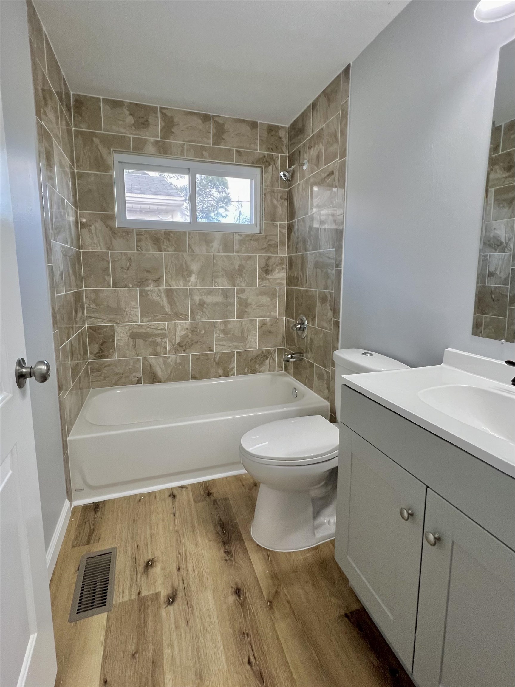 New tiled tub/shower, toilet and vanity.
