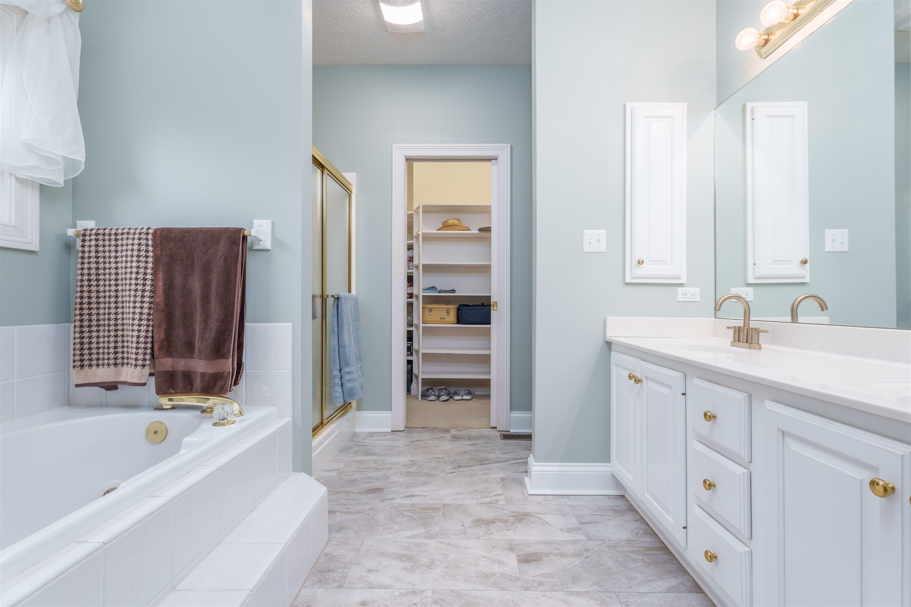 Master on-suite bath includes double sink vanity, jet tub, walk-in shower, walk-in closet & updates.