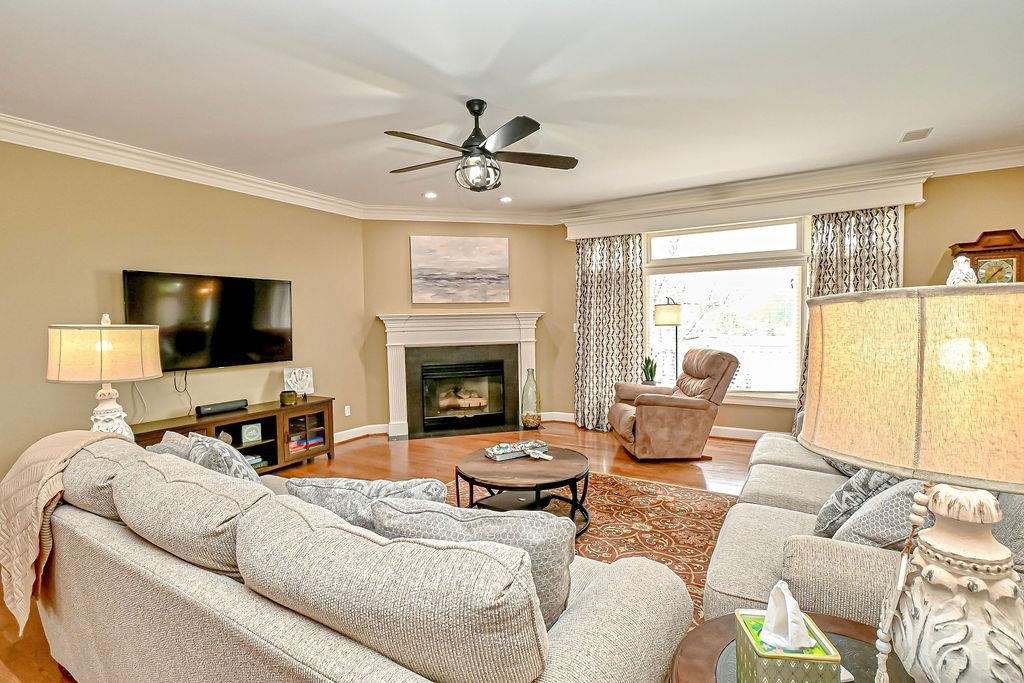 Massive great room features a bank of windows to enjoy the view, corner fireplace, crown moulding.