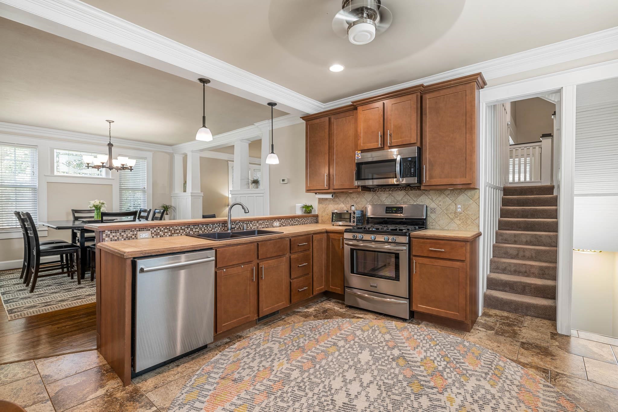 Stainless Steel Appliances, 2 sinks, and tiled backsplash