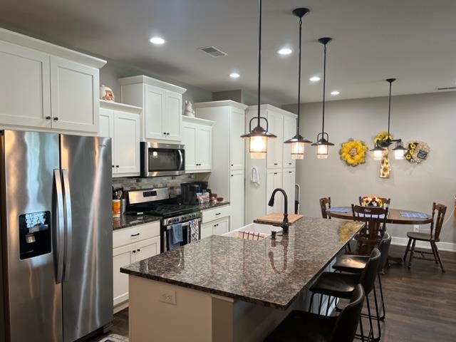 PHIL'S CUSTOM CABINETS WITH ROLL OUTS. GAS STOVE, GRANITE COUNTERS