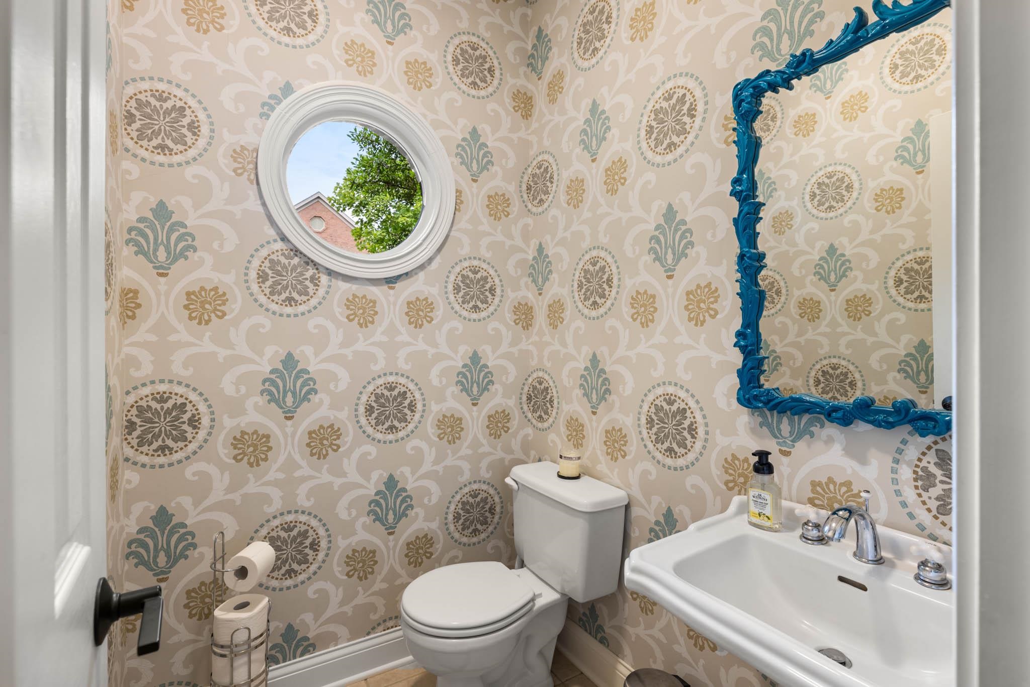 Half bath between kitchen, garage and laundry area.