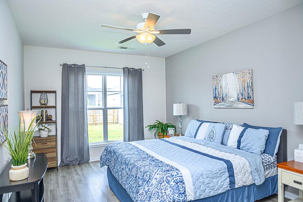 Spacious primary bedroom offers a private bath with ceramic shower, double vanity & walk-in closet.