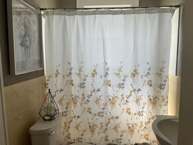 Updated bathroom features a newer vanity, original tile, and linen closet.