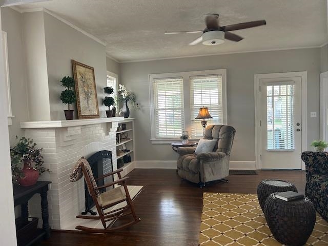 Spacious living room features a gas fireplace, built-ins, tons of windows, and hardwood floors!