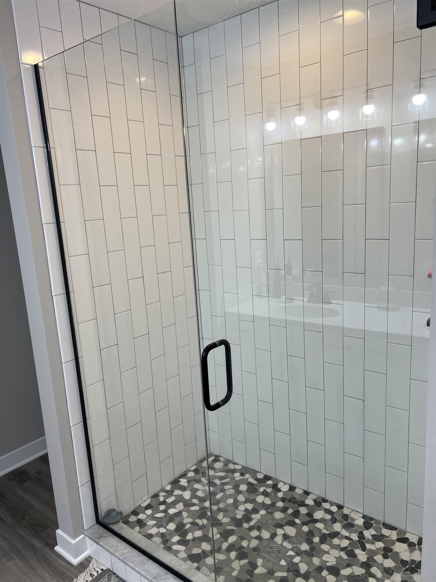 Upgraded walk-in tiled shower with glass doors