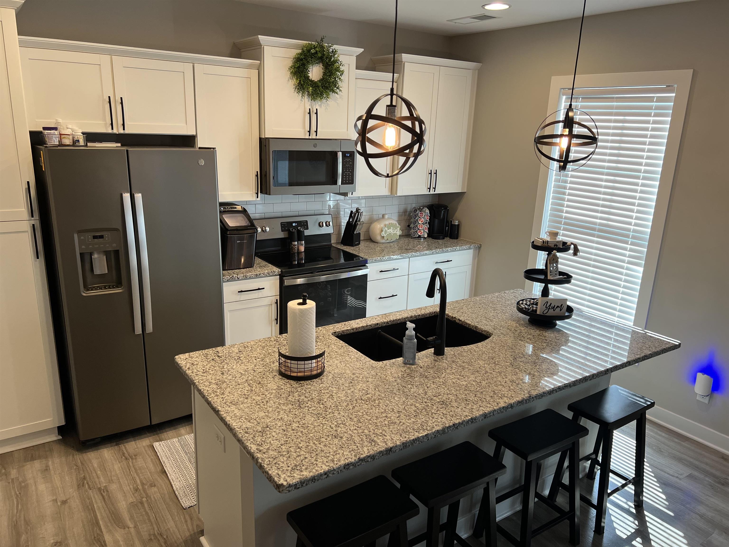 This wonderful kitchen has several upgrades including the granite counter tops, faucet, and lighting