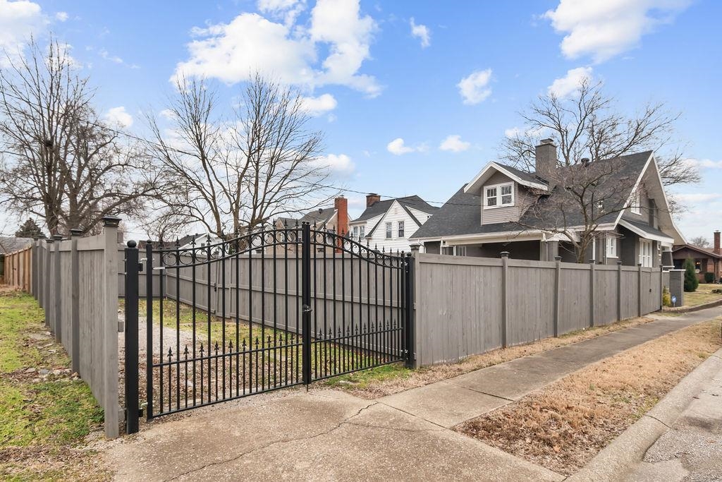 Check out the gorgeous fencing and ornamental gate, which not only provides privacy but beauty!