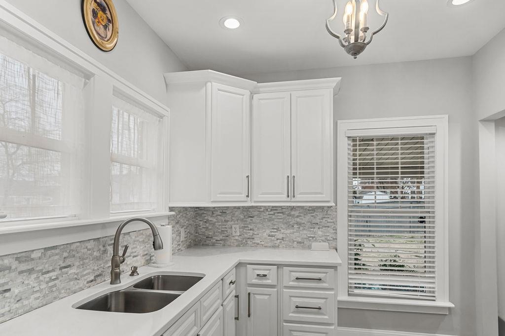 Gorgeous chef's kitchen has newer cabinets, granite, tiled back splash and more!