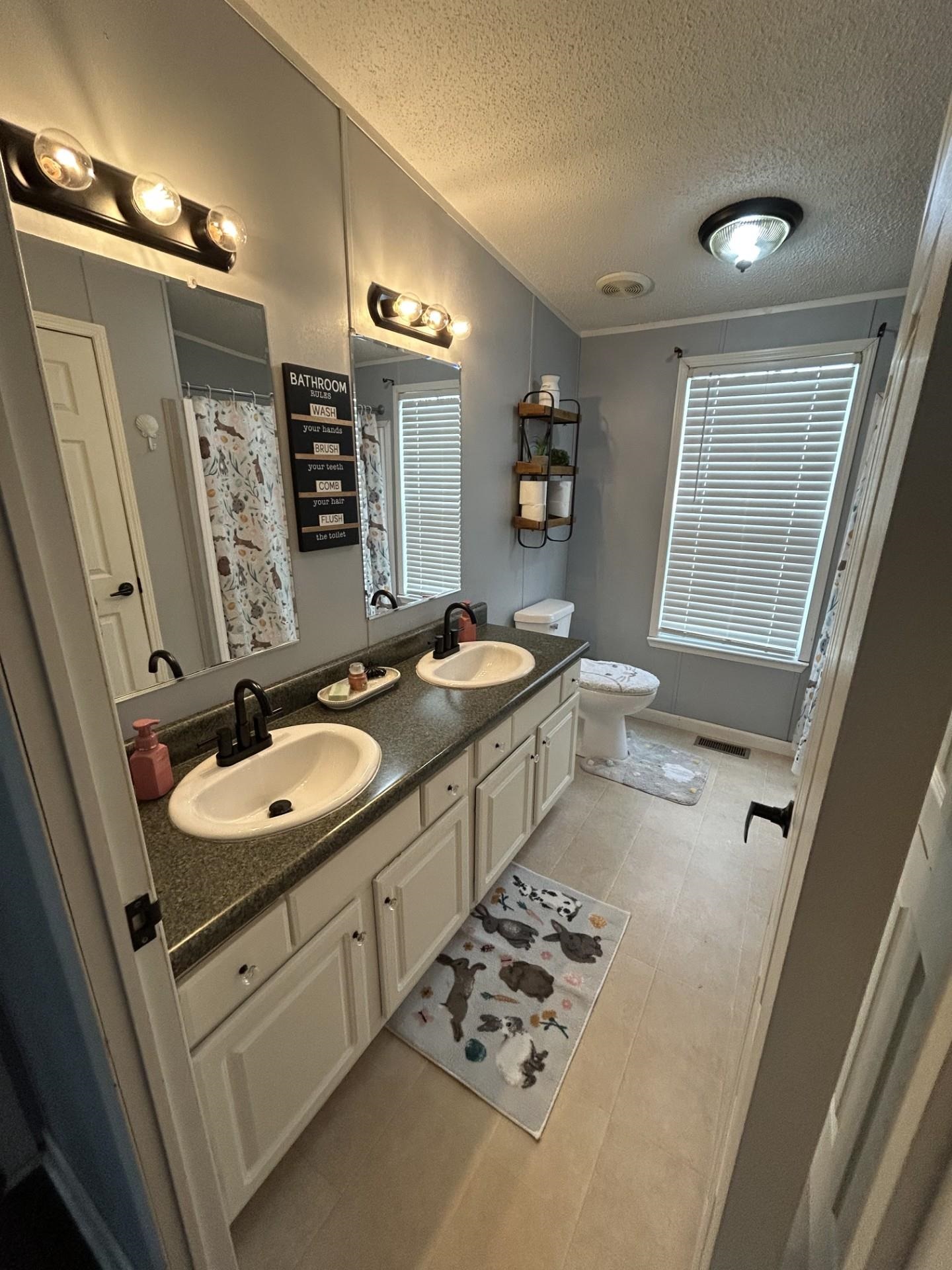 This large 2nd bathroom has plenty of room to share with a double vanity and shower/tub combo