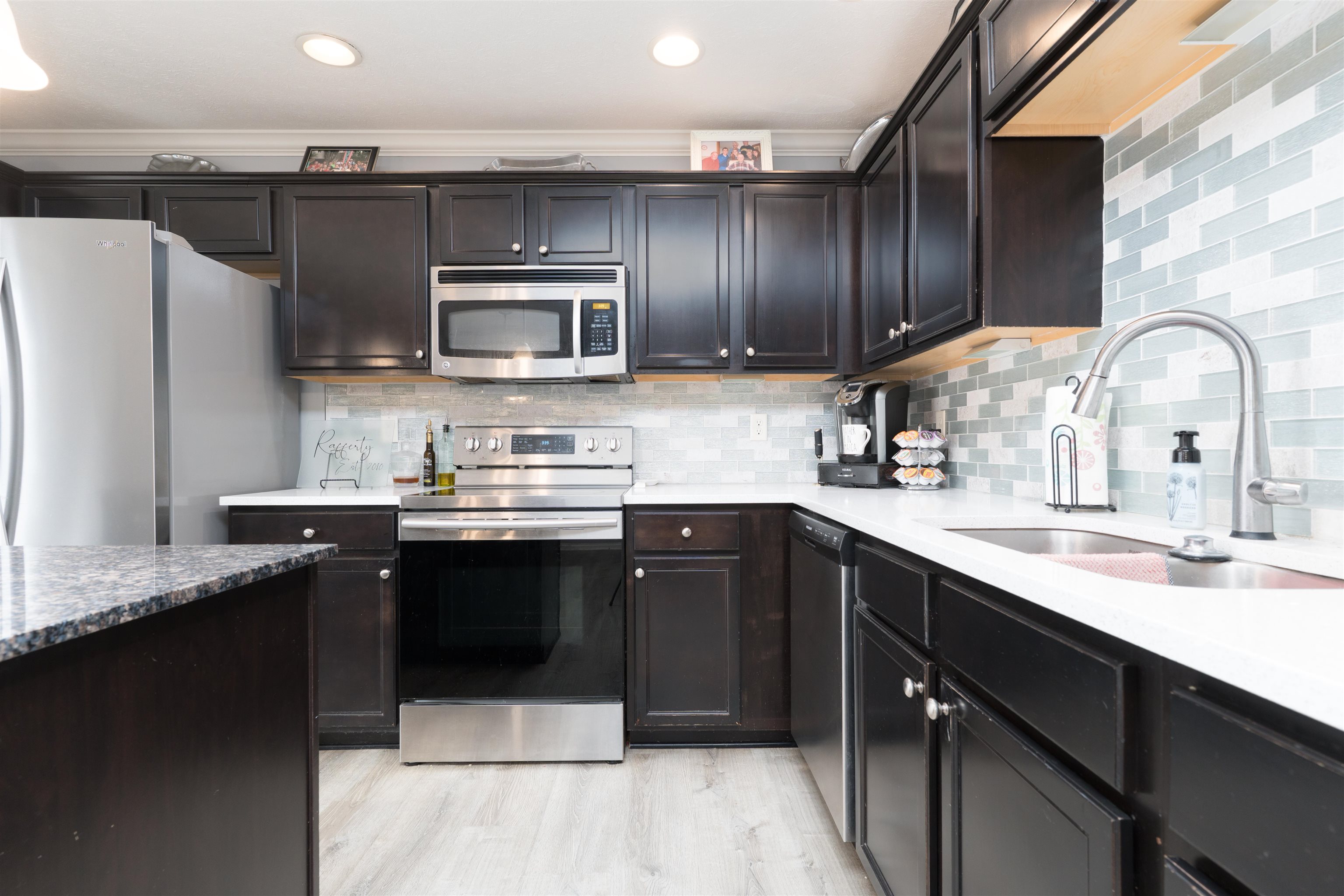 New backsplash recently installed, including newer quartz countertops for a fresh finished touch.