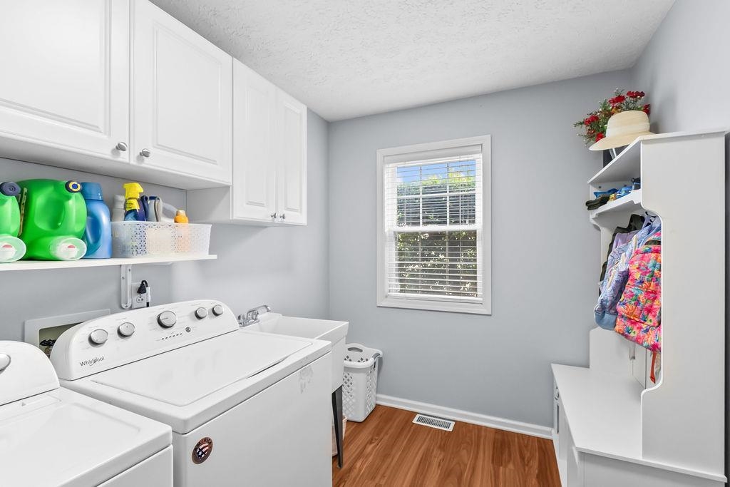 First floor laundry room has lots of cabinets and a drop zone!