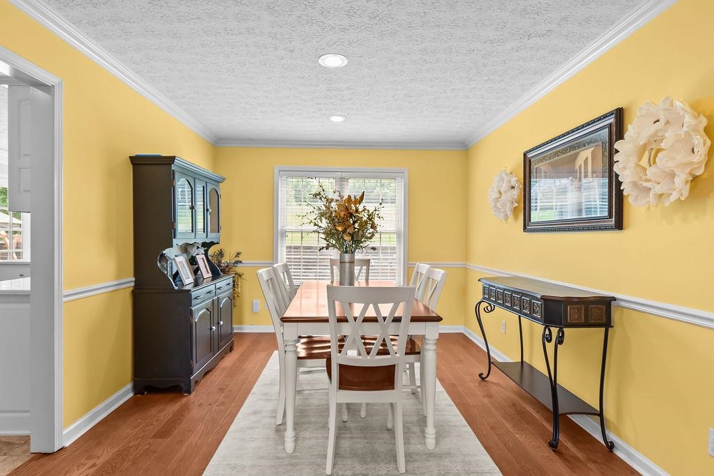 Formal dining room with hardwood floors and crown moulding