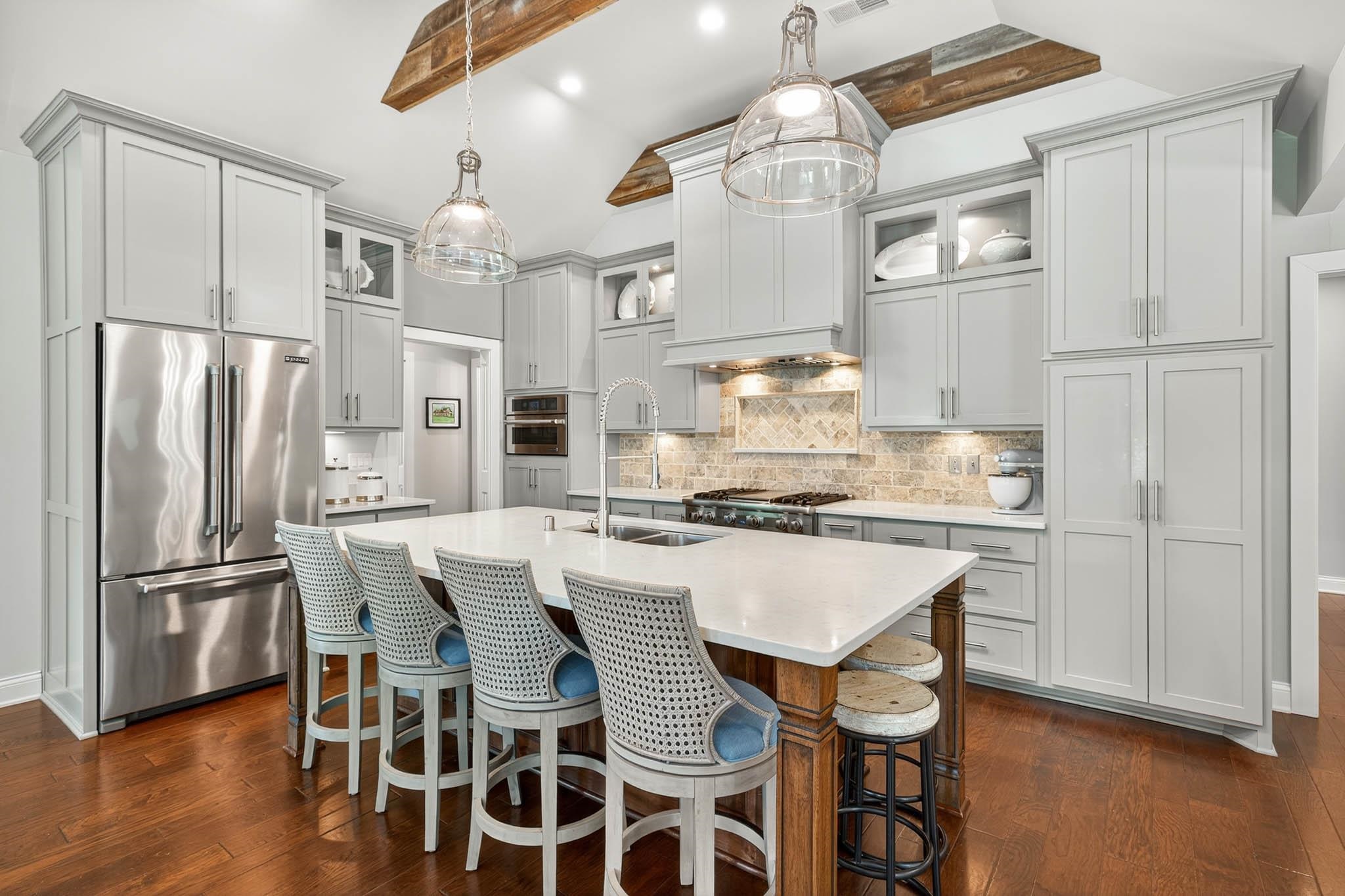 Professional-grade Viking Range, Stainless appliances, Quartz, island seating, roll out cabinetry