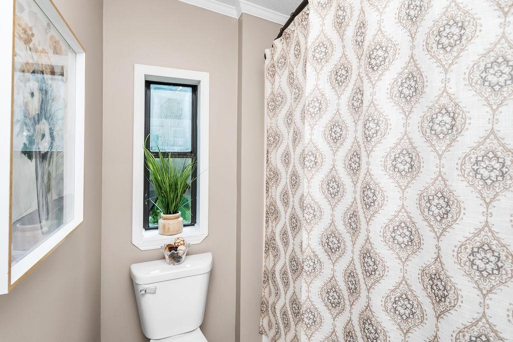 Private commode and bathing area for the primary bathroom!