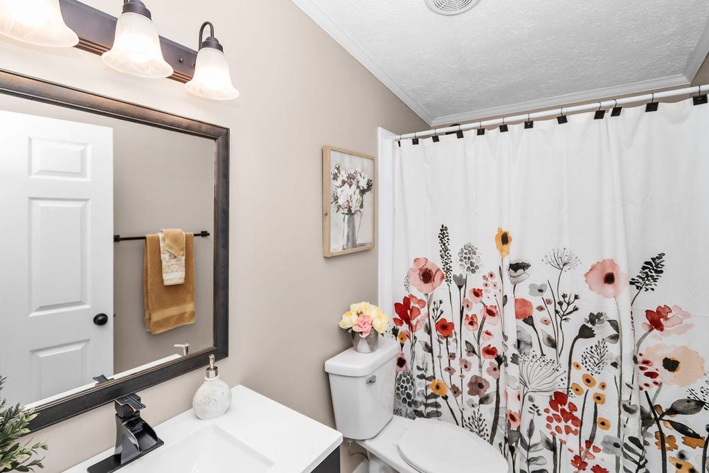 Guest bath features new vanity, ceramic flooring and light and plumbing fixtures.