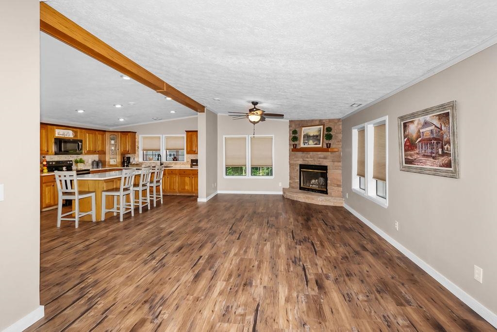 Large family room with corner fireplace opens into kitchen.